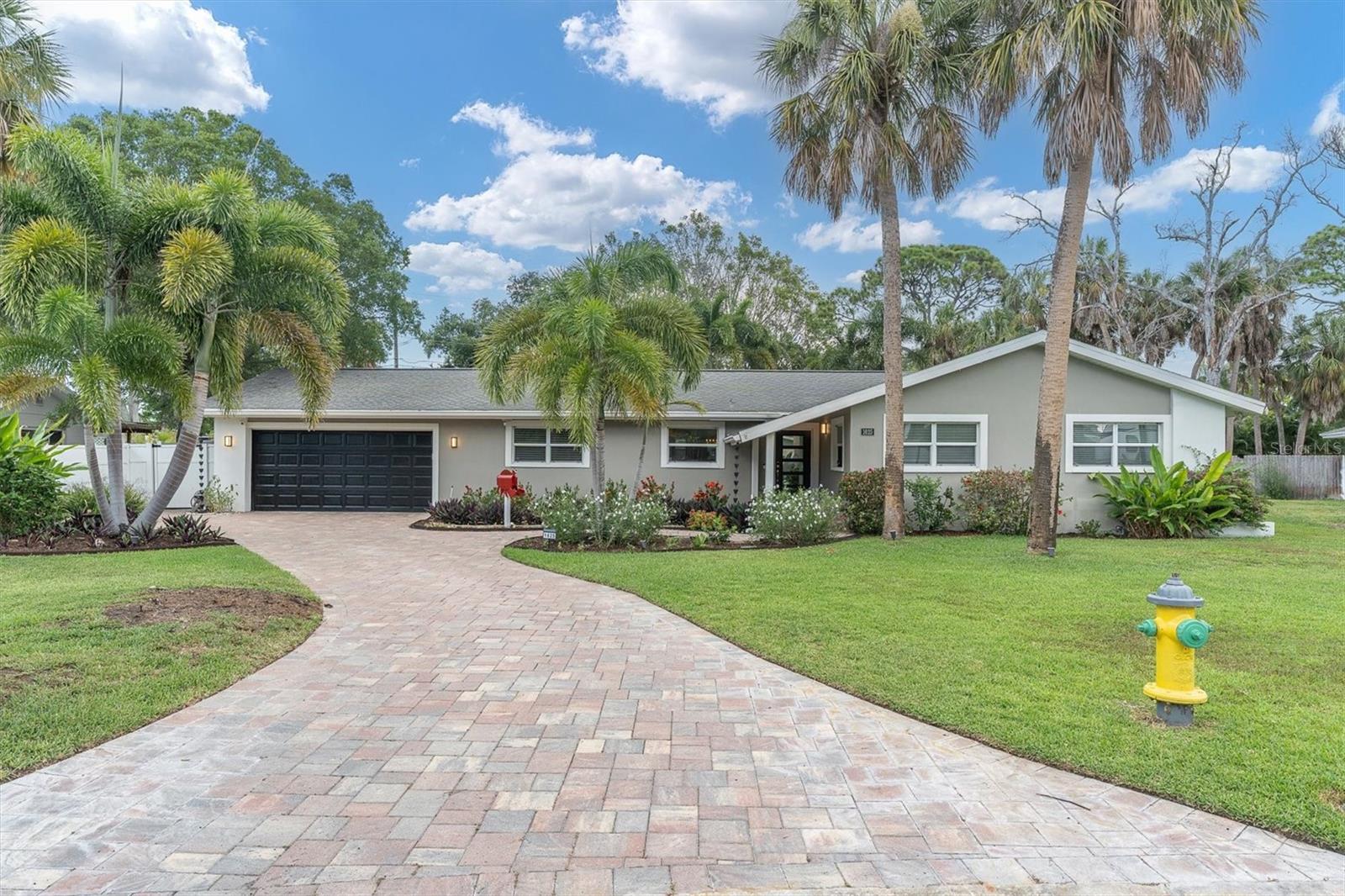 Beautifully renovated 4BR/3BA pool home in the heart of Shore Acres! Blending mid-century modern style with today’s smart technology, this move-in-ready home offers both design and peace of mind with hurricane impact windows and extensive recent upgrades, including a new roof, salt cell (2026), water heater, appliances, electrical panel (2025), HVAC, pool heater, and pool pump (2024). Inside, enjoy an open-concept layout with tile flooring throughout, tailored cabinetry, designer finishes, and a chef-inspired kitchen featuring quartz countertops, a large island, and premium appliances. The spacious primary suite offers an oversized walk-in closet and spa-inspired bath. A standout feature is the air-conditioned garage flex space, ideal for a home gym or office, while still offering plenty of room for parking and storage. Step outside to your private tropical retreat with a screened lanai, saltwater pool, gazebo, lush landscaping, and multiple spaces for outdoor entertaining. Located in a sought-after waterfront community just minutes from downtown St. Petersburg, waterfront parks, golf, and the new Shore Acres Rec Center. Experience the perfect blend of character, comfort, and Florida living!