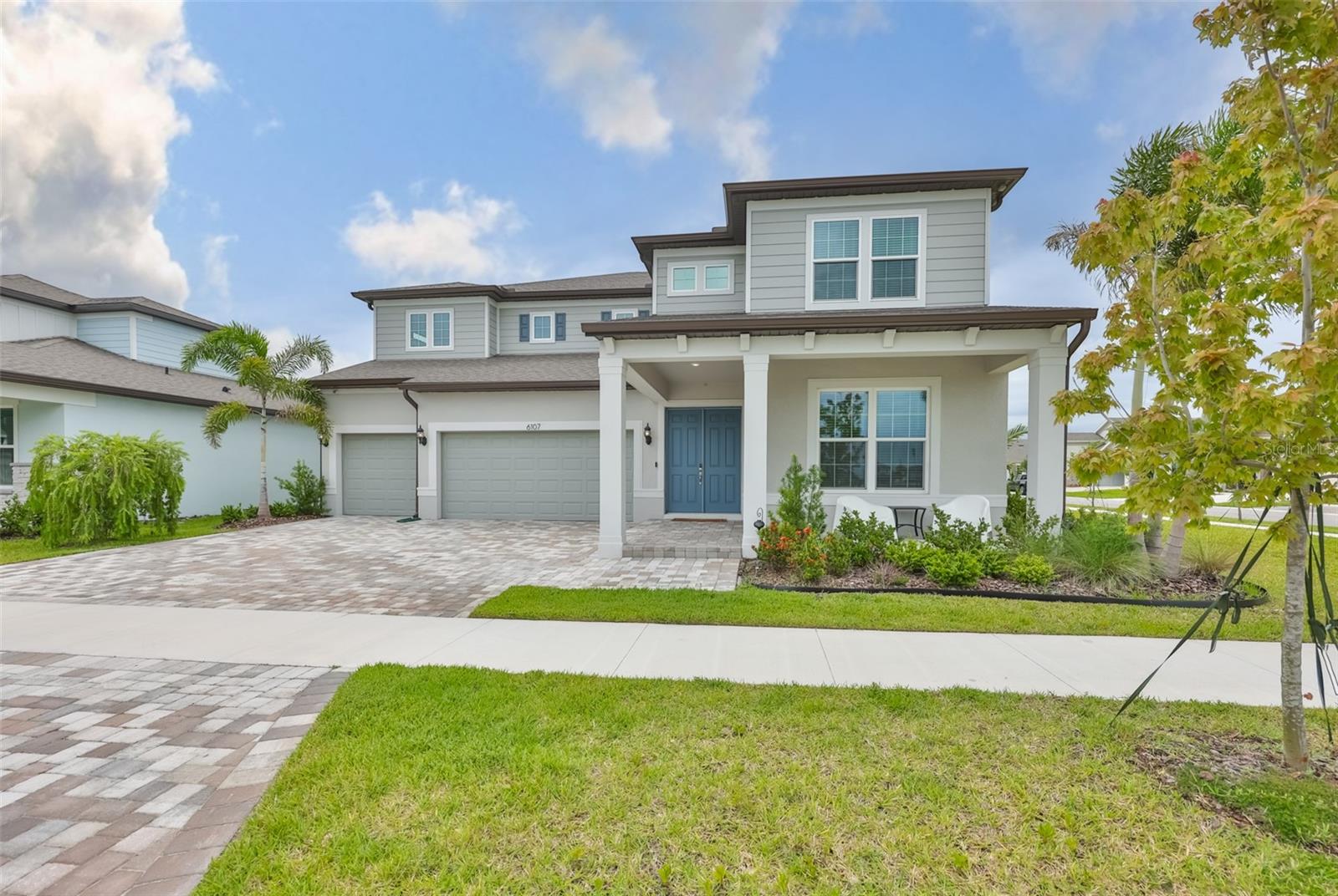 Welcome to the Roseland, Pulte's largest floor plan in Waterset, perfectly positioned on a premium ¼-acre corner lot with over 4,200 square feet of beautifully designed living space. With Pulte sold out of this model in Waterset, this is a rare opportunity to own one of the community's most desirable homes on one of the most desirable lots. Just one year old and meticulously maintained, this stunning residence makes an immediate impression with its tropical landscaping, paver driveway, oversized 3-car garage, and inviting covered front porch. Inside, the expansive floor plan offers exceptional flexibility and comfort, with thoughtfully designed spaces for entertaining, working, and everyday living. At the heart of the home is the gourmet kitchen, featuring quartz countertops, premium KitchenAid appliances, an eat-in area, a spacious walk-in pantry, and a butler's pantry complete with a beverage refrigerator. The kitchen flows seamlessly into the large family room, where pocket sliding doors open fully to the screened lanai, creating the ultimate space for entertaining or indoor-outdoor living. The first floor also includes a game room next to the half bath, a private office (both offering potential as additional bedrooms), and a versatile dining/flex space to fit your lifestyle needs. Upstairs, a dramatic catwalk overlooks the living areas below and leads to three secondary bedrooms, including one with a private en-suite bath and two connected by a Jack-and-Jill bathroom. All bathrooms have been upgraded with walk-in showers. The luxurious primary suite serves as a private retreat, featuring a sitting area, dual walk-in closets, and a spa-inspired bath with dual vanities, a soaking tub, and a large walk-in shower. Additional upgrades include a screened lanai with paver floor, epoxy garage floors, electrical outlets in the floor of the living room and catwalk, gutters around the house, hardwired exterior security cameras, landscape accent lighting, a water softener, utility sink plumbing in the garage, and professional landscaping with tropical palm trees. Located within walking distance of Waterset's newest amenity center, the Founders Club, residents enjoy access to a resort-style pool with lap lanes, fitness center, pickleball courts, playground, clubhouse, co-working spaces, and community gathering areas. Living in Waterset is more than owning a home - it's embracing a vibrant lifestyle. Enjoy year-round community events, concerts, food trucks, holiday celebrations, miles of trails, and four exceptional resort-style amenity centers. Visit Waterset's website to see all there is to do. This extraordinary home offers the perfect blend of luxury, space, and community. Don't miss your chance to make it yours!