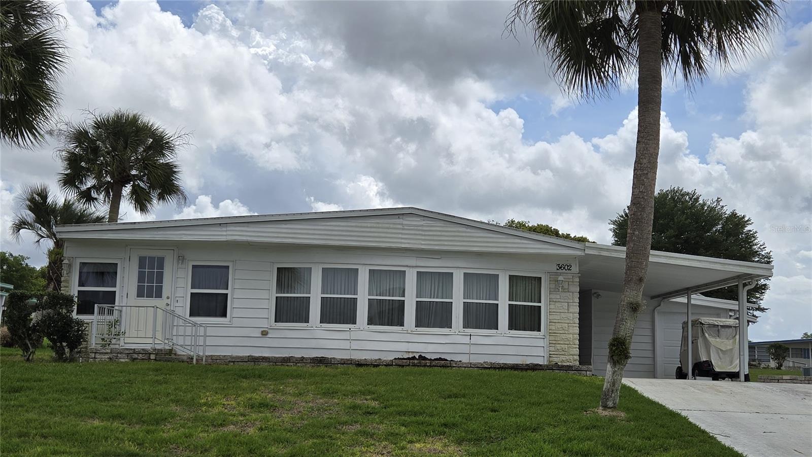 PRICED TO SELL!  2-Bedroom 2 Bath home in Zellwood Station has large outside storage area, laundry and golf cart garage. This house has been replumbed, insulated windows, and Membrane roof installed in 2022.  Large living room has beautiful windows that allow tons of natural light.  There is a Florida room off the main living room that can be used as an office or extra living space. Some TLC will make this house something special! Zellwood Station is a Resident Owned 55+ Golfing Community located between Apopka and Mt Dora.  We have a 72 Par golf course, 4 pools, pickleball and tennis courts; water exercise and line dancing classes and our own Whistle Stop Restaurant and Lounge with banquet facilities.  There is always something to do here.  Close to the 429 for easy access to airports and attractions, we are close to shopping, restaurants, medical facilities and churches.  Come and see what we have to offer!