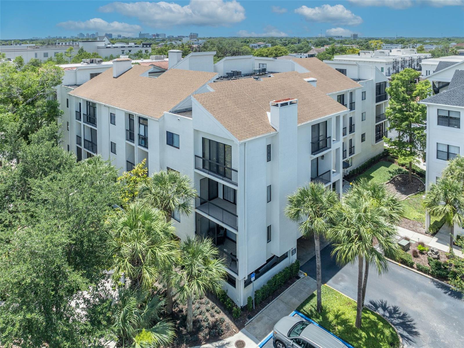One or more photo(s) has been virtually staged. Welcome to Park West Condominiums — one of Winter Park’s most coveted and rarely available condominium communities, ideally located just one block from the boutiques, dining, and charm of Park Avenue. This unique 4th floor residence offers an exceptional combination of space, privacy, and potential. Featuring 3 bedrooms and 2 bathrooms, the expansive floor plan has been enlarged by enclosing two patios, creating generous living spaces rarely found in condominium living. Vaulted ceilings, skylights, and abundant natural light enhance the open, airy feel throughout the home, while the top-floor location provides remarkable tranquility and privacy. The spacious kitchen offers ample counter space, a breakfast bar, and excellent cabinet space, while the living area is anchored by a fireplace — another uncommon feature in condo living. Large bedrooms, a sizable in-unit laundry room with extensive storage, and an oversized attic provide an extraordinary amount of storage seldom seen in comparable properties. The primary suite features vaulted ceilings, a walk-in closet, and a spacious bathroom layout. For maximum flexibility, the second bedroom, featuring a bright Sun Room alcove, connects to the primary bedroom so it could also be utilized as a private den. Recent unit improvements include a NEW HVAC system, a NEW Water Heater, and Plumbing updates. A reserved covered parking space is included, along with plentiful guest parking for visitors. Residents of Park West enjoy a secure gated entrance, community pool, tennis court, on-site community manager, and beautifully maintained grounds with extensive recent community improvements completed. Association fees include water, sewer, and trash service, creating a truly low-maintenance “lock-and-leave” lifestyle ideal for travelers or seasonal residents. While this condo presents an exciting opportunity for personalization, the location, floor plan, and features make this an exceptional offering with tremendous potential. Opportunities in Park West are exceedingly rare — this is your chance to create something truly special in the heart of Winter Park.