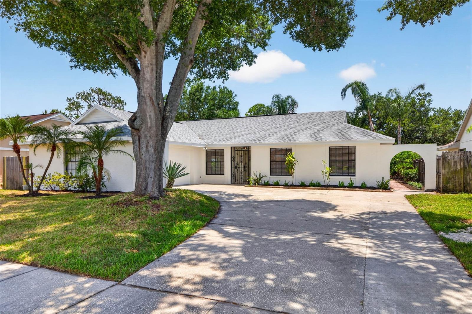 Virtually Staged. Welcome to this beautifully renovated 4-bedroom, 3-bathroom home with a separate dedicated office/flex space, thoughtfully redesigned with modern finishes and a functional layout that offers flexibility for a variety of lifestyles. Located in the desirable Country Place community of Carrollwood, this block construction home features a 2-car garage and combines updated style with comfortable everyday living.

As you step inside, you're greeted by vaulted ceilings, new luxury vinyl plank flooring throughout, new interior and exterior paint, new lighting throughout, and new baseboards that create a bright and inviting atmosphere. The open-concept living and dining areas flow seamlessly into the fully remodeled kitchen, making the home ideal for both entertaining and daily life. The kitchen features new cabinetry, quartz countertops, a seamless quartz backsplash, (2026) stainless steel appliances, hood vent, and bar seating for casual dining.

The spacious living room opens through large sliding glass doors to a covered and screened lanai, extending the living space outdoors and creating the perfect setting for relaxing or hosting guests. Beyond the lanai, the fully fenced backyard offers privacy, mature trees, and fresh landscaping.

The split-bedroom floor plan provides excellent functionality. Two secondary bedrooms are positioned near a beautifully updated hallway bathroom featuring a tub and shower combination. A third bedroom includes its own private en-suite bathroom, making it an ideal guest suite, or in-law space. The primary suite is tucked away at the rear of the home and offers a peaceful escape complete with an updated en-suite bathroom, a walk-in closet, and an additional flex room that can be used as a nursery, sitting room, second office, home gym, hobby space, or additional storage area depending on your needs.

All three bathrooms have been completely updated with new vanities, tile work, updated fixtures, and new toilets. With no carpet throughout the home, the luxury vinyl flooring provides both durability and easy maintenance.

Conveniently located near numerous parks, shopping, dining, and major commuter routes, this move-in ready home offers the perfect combination of modern updates, flexible living spaces, and an established neighborhood setting. Roof (2022) HVAC (2022) Water Heater (2023)