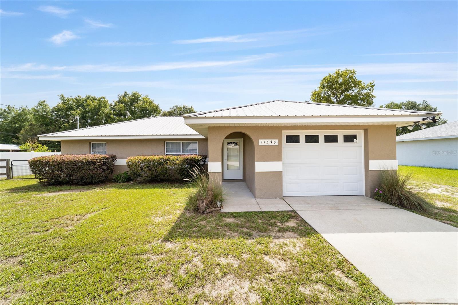 Virtually Staged. AFFORDABLE, MOVE-IN READY HOME WITH NO HOA & DETACHED BARN! This well-maintained 3-bedroom, 2-bathroom concrete block and stucco home sits on a spacious 0.32-acre lot in centrally located Belleview Ridge Estates, NOT in a flood zone. The split floor plan features a primary suite with a walk-in closet and en-suite bath. Major updates include a NEW lifetime metal roof (2019) and NEW HVAC (2020). Enjoy a fully fenced backyard, screened porch, a detached metal barn with enclosed storage that's perfect for a workshop, boat, ATV, or hobbies, plus an additional storage shed for all your tools and equipment. Ideal for first-time home buyers, downsizers, or anyone seeking an affordable home with NO HOA! Conveniently located near shopping, dining, schools, medical facilities, and major highways, this home offers exceptional value, comfort, and convenience.