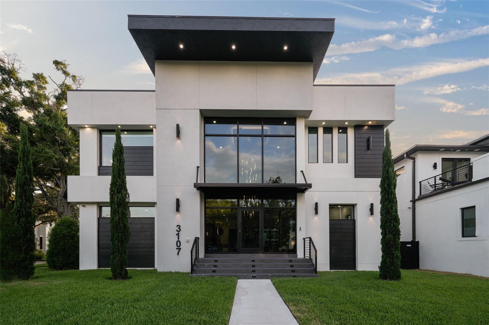 Nestled in Sunset Park, this contemporary masterpiece boasts 7 beds, 8.5 baths, and unrivaled architectural design. The grand
entrance features 24' ceilings and a floating staircase, leading to a dining room with a wine cellar. The chef's kitchen dazzles with
Calcutta Marble countertops, Thermador appliances, and a hidden pantry. The great room, den, and en-suite bedroom complete the
first floor. Upstairs, the primary suite offers a walkout balcony and lavish ensuite bath, alongside five additional bedrooms and a
media room. The third floor impresses with a marble waterfall countertop whiskey bar, leading to a rooftop terrace. Outside, a
saltwater pool, spa, and outdoor kitchen await in the tropical oasis backyard. Additional features include a glass entrance, security
cameras, 3-car garage, and elevator. Just minutes from Tampa's amenities, this home epitomizes luxury living.