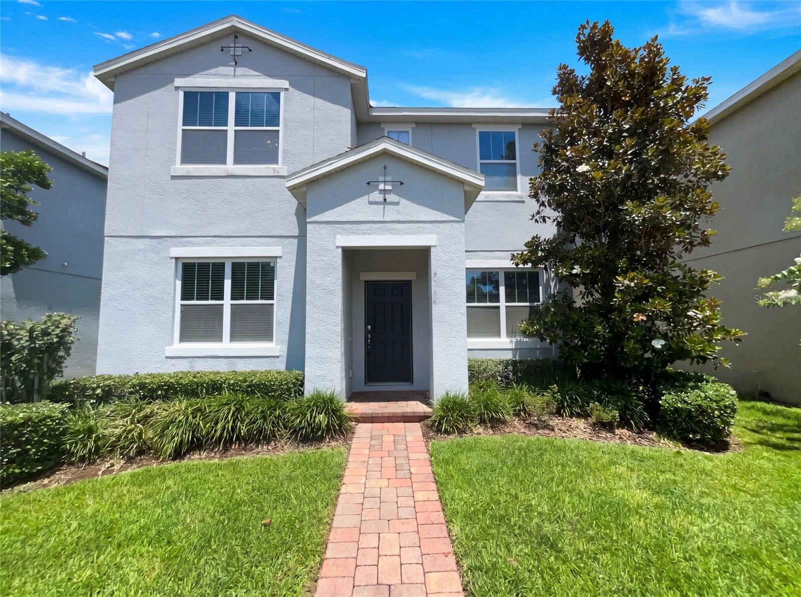 Virtually Staged. 2264 Ficus Aly is a 2-story Apopka single-family home built in 2018, offering 3 bedrooms and 2 bathrooms across 2,302 square feet. The kitchen features dark cabinetry, granite countertops, a center island, and stainless steel appliances. The open main level connects the kitchen and living area with hardwood-style flooring, and a staircase with iron railings leads to the upper level. The primary bedroom includes a walk-in closet, and the primary bathroom offers a double vanity with dark cabinetry and a separate walk-in shower. A covered screened patio extends the living space outdoors, and a 2-car attached garage completes this well-maintained residence.. Included 100-Day Home Warranty with buyer activation