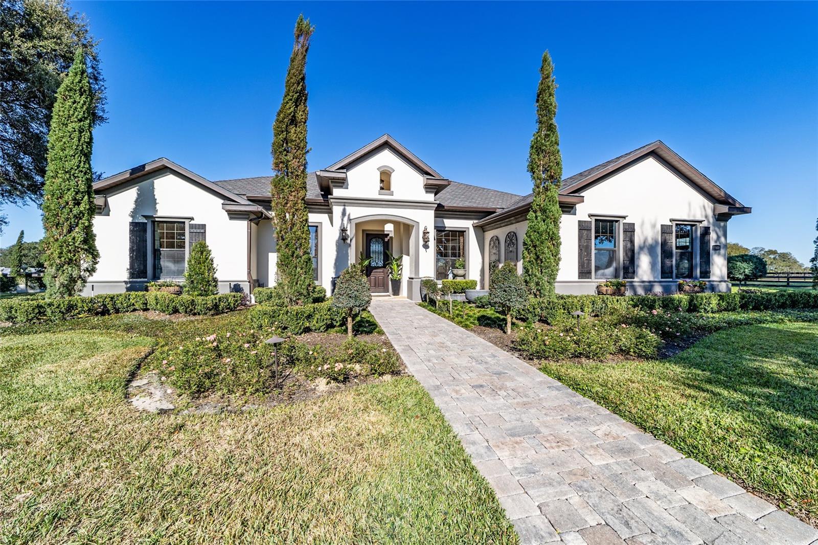 Discover the unparalleled luxury in this exquisite 2018 custom built Triple Crown home nestled on a sprawling 28 acre estate located in the Northern part of Marion County Florida. The meticulously designed farm within the well known equine subdivision of Cherokee River and Cardinal Hill will appeal to every equine enthusiast. The three bedroom,  three-bath layout  offers a harmonious blend of luxury and comfort. Step outside to a walled private garden, a tranquil retreat adorned with an array of fruit trees, shrubs and elegant landscaping. The Premier Stable boasts a block center aisle 13 stall barn with several oversized stalls. The Stable is equipped with the essential amenities, wash stalls, tack room, storage and feed as well as designated run outs for some of the stalls. This Stable also has a state of the art newly completed apartment with its own dedicated outdoor living space.Comprehensive Equestrian amenities also include a fenced grass arena, viewing Gazebo, Quarantine barn, and Round Pen. This exceptional property is not just a home; its a lifestyle. Offering the perfect blend of luxurious living, equestrian facilities, and natural beauty, its designed for those who seek tranquility and elegance. Embrace the opportunity to own this piece of paradise that can be sold turn-key. Also consider the 20 acre parcel also for sale that connects to it and join them for the epitome of all Equine Estates!