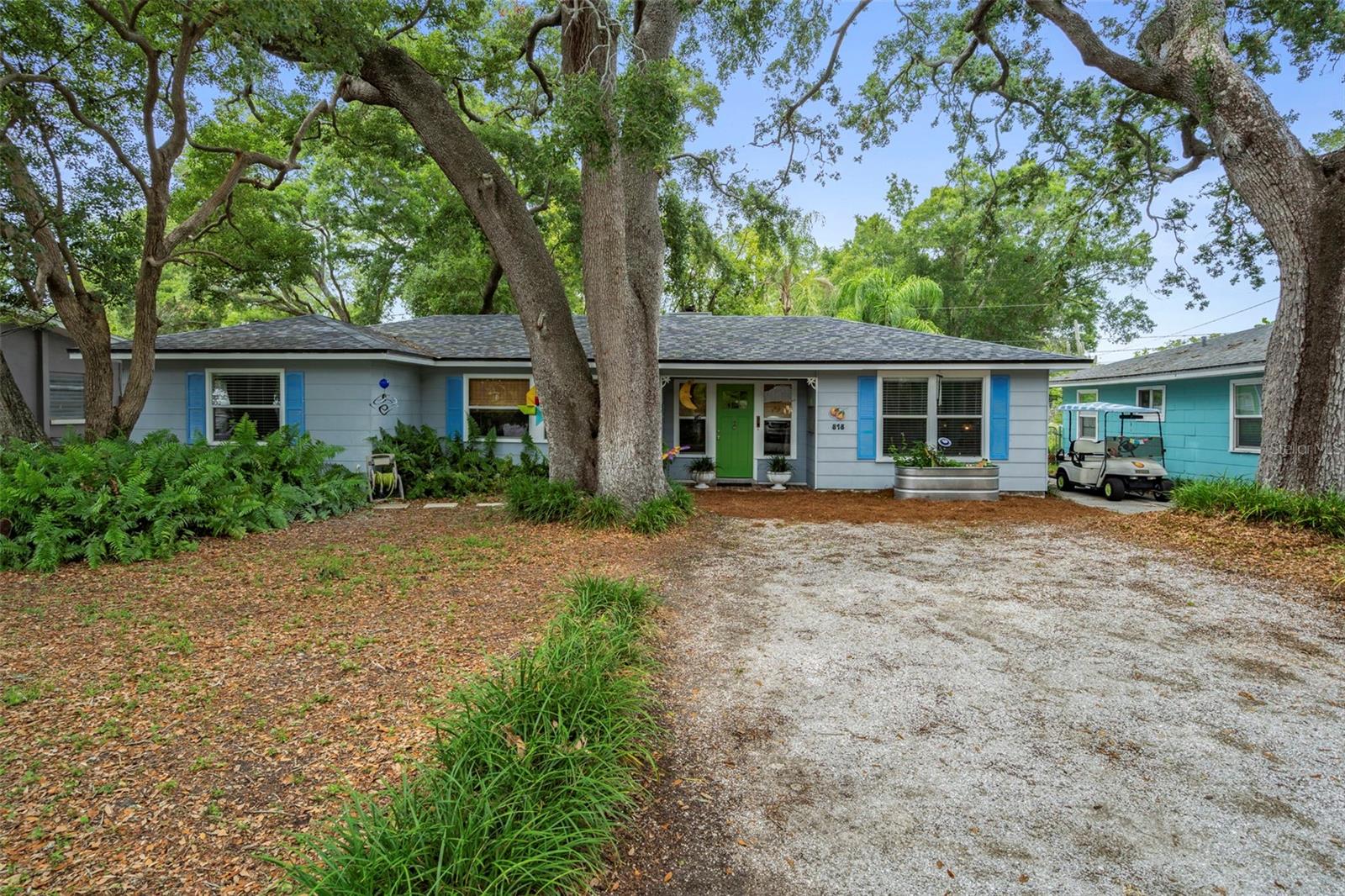 GOLF CART INCLUDED IN SALE!  If you're not familiar with Dunedin, you're in for a treat!  Welcome to this HIGHLY DESIRABLE, easily WALKABLE, PET & GOLF CART FRIENDLY coastal community with rich Scottish heritage & laid-back, old Florida charm!  Walk, bicycle or drive your golf cart from your new home at 818 Wilkie to all the great things Dunedin has to offer including Downtown, the Pinellas Trail, the Fenway Hotel, TD Ballpark, the Dunedin Marina, Edgewater Park, the famous Bon Appetit restaurant & more!  Built in 1957 and situated HIGH & DRY on a BEAUTIFUL LOT with a truly PARK LIKE SETTING, this quaint residence is framed by a majestic canopy of MATURE OAK TREES that provide dappled sunlight & NATURAL PRIVACY.  Adding to the natural setting is a shell covered driveway, pine needle covered walkway and a welcoming covered front entry.  With a generous 1690 sf of living space, the interior of this METICULOUSLY MAINTAINED & LOVINGLY CARED for home (that has been adored by the same family for 48 years) features three generously sized bedrooms, a full bathroom, a cozy living room, spacious family room, large kitchen & a centrally located dining area.  LAMINATE WOOD FLOORING spans the living areas and primary bedroom.  The kitchen, bathroom and 2 secondary rooms boast original TERRAZZO floors.  Unlike some homes of this era, this one features a SPACIOUS KITCHEN that was thoughtfully updated and features BEADBOARD BACKSPLASH, WOOD CABINETRY (some with decorative glass doors) and several convenient storage drawers for pots n pans & more.  STAINLESS STEEL APPLIANCES, a window for NATURAL LIGHT and an opening to the family room provide additional conveniences.  The living room has a large window overlooking the LUSH FRONT YARD and also boasts an ACCENT WALL with SHIPLAP DETAIL.  Just beyond you'll find 2 bedrooms and the full bathroom with an updated vanity, vintage tile and a shower curtain with bright Florida oranges that have become the citywide symbol of Dunedin.  The LARGE BEDROOM at the front of the house boasts a huge closet and CROWN MOLDING and currently serves as a home office.  The back bedroom is smaller and overlooks the PRIVATE BACKYARD.  On the OPPOSITE SIDE OF HOUSE is the PRIMARY BEDROOM with ceiling fan & built in closet as well as a UTILITY ROOM that is home to the WASHER & DRYER, hot water heater, air handler & storage space.  Relaxing in the FAMILY ROOM is a DREAM as it OVERLOOKS THE BACKYARD and has a DECORATIVE, BUILT IN FIREPLACE that can be converted into a gas fireplace if desired. FRENCH DOORS lead outside to the OPEN BACK PATIO and PRIVATE BACKYARD that is FULLY FENCED and features LOW MAINTENANCE ground cover.  A FIRE PIT and large STORAGE SHED round out the back.  As an added BONUS, the GOLF CART WILL STAY for the next owner of this beautiful home- with acceptable offer.   NO FLOOD ZONE! NO HOA!  And better than $$ communities with amenities, Dunedin offers so much more to do within a small radius.  There's also a RECREATION CENTER 2 MI away.  Dunedin residents can also register for a pool pass at the FENWAY HOTEL plus enjoy a SUNSET COCKTAIL in the ROOFTOP BAR or outside on the lawn in Adirondack chairs.  It's also home to Florida's oldest Microbrewery.  No corporate chains located here though!  YEAR-ROUND EVENTS including CONCERTS, FESTIVALS, PARADES, BASEBALL GAMES, A FARMERS MARKET AND MORE will keep you busy!  Honeymoon Island State Park/Beach with dog beach and ferry to Caladesi Island is only 5 miles away!