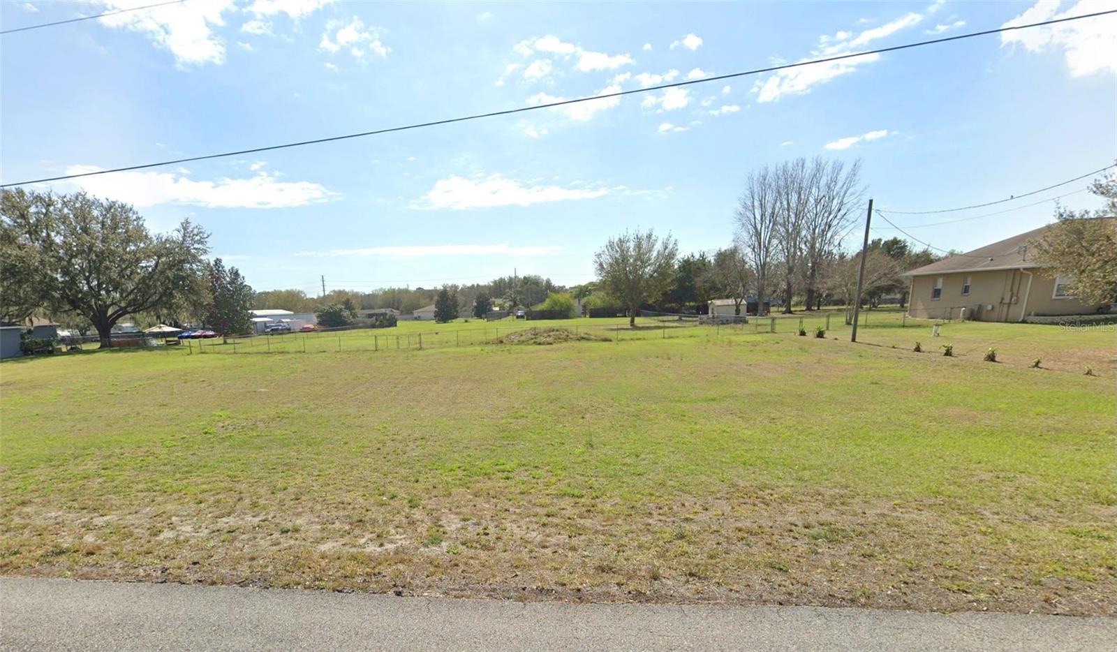 Ready to build in bustling Wesley Chapel? Want the country feel but close to shopping, dining and major roadways? Come check out this beautiful 1.003 acre semi-fenced lot that is high and dry with great potential. Lot is ready to go with one minor tree that can stay or go as you see fit. Wonderful neighborhood with NO HOA, so bring the toys and have plenty of room to roam. Opportunities like this do not come around often. NO flood insurance is required.