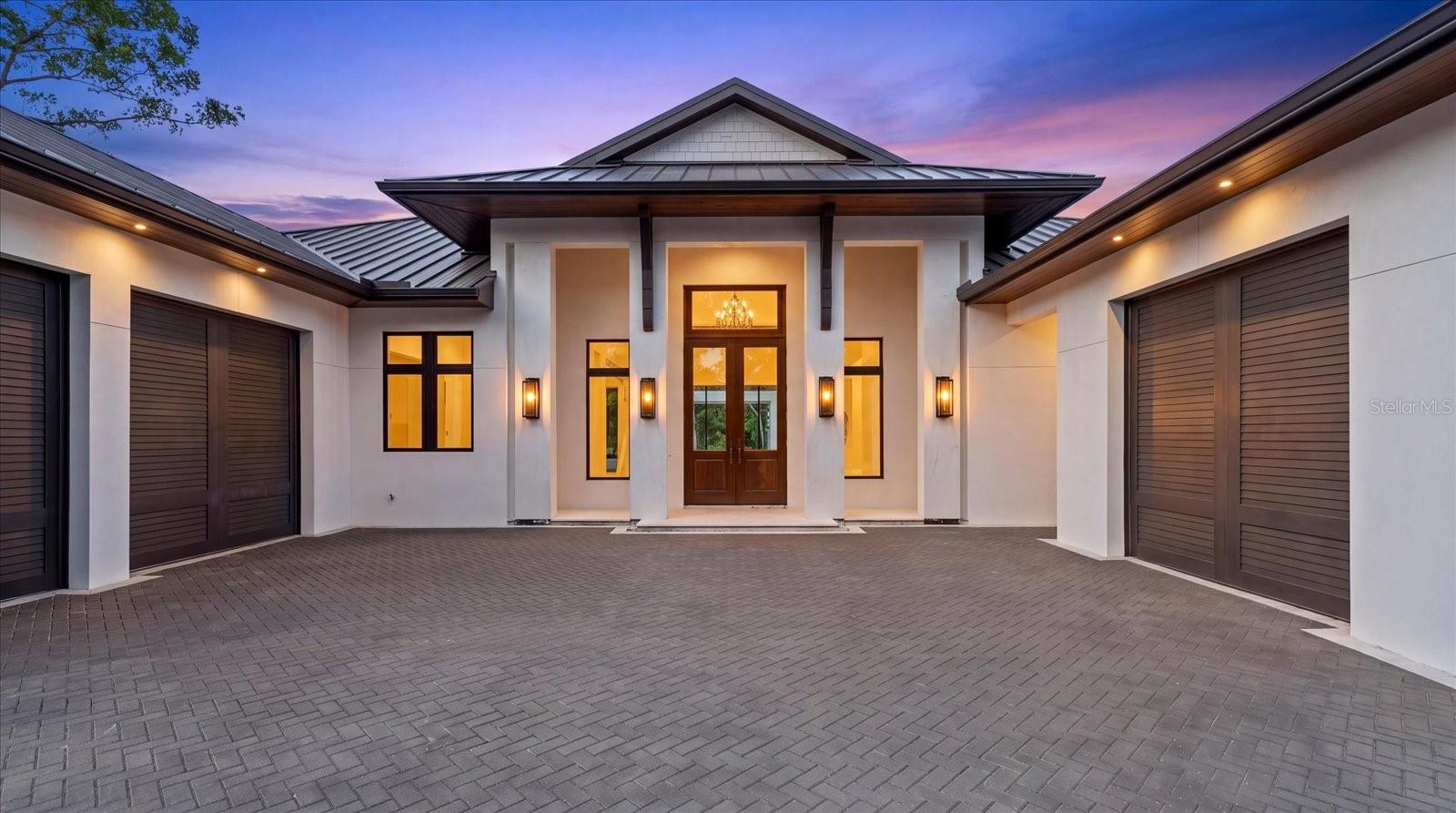 Ready NOW. This exceptional waterfront estate by Dynan Construction, Sarasota's premier luxury builder, offers a rare opportunity to own a brand-new custom home without the wait. Renowned for impeccable craftsmanship, architectural integrity, and timeless coastal design, Dynan delivers a residence built to the Fortified Home Gold Standard, providing enhanced resilience against Florida's coastal elements while maintaining uncompromising luxury.

Thoughtfully curated, every space reflects sophisticated design, elevated finishes, and enduring style. The gourmet kitchen is appointed with a premium Thermador appliance package, while Brizo plumbing fixtures are featured throughout the home, adding a refined level of quality and craftsmanship.

This five bedroom single-story residence offers seven bathrooms - five full bathrooms, a dedicated pool bath, and an additional powder bath, creating a functional layout designed for both everyday living and effortless entertaining.

Situated within the exclusive Hidden Harbor community—an intimate waterfront enclave known for its mature landscaping and lush, canopy-lined streets—the property enjoys a deep-water canal with direct access to Sarasota Bay and the Gulf of America.

Designed to embrace Florida's indoor-outdoor lifestyle, expansive 10-foot sliding glass doors open to a resort-inspired outdoor living area complete with a custom pool and spa that is elevated to the finish floor of the home, covered pergola, and fully equipped outdoor kitchen. From sunrise cruises to sunset returns, enjoy the convenience of a private outdoor shower located just steps from the new dock and 10,000-pound boat lift. Every detail has been thoughtfully considered, from the seamless entertaining spaces to the carefully selected designer finishes throughout.

Additional features include smart-home lighting controls, prewiring for security cameras and blinds,  indoor/outdoor surround sound, and preparation for a future whole-house generator, providing convenience and peace of mind. Dual garage spaces—including a two-car garage and an additional one-car garage—offer the versatility to accommodate vehicles, water toys, bicycles, and storage with ease.

Located just a short bike ride from the world-renowned Siesta Key Beach, this remarkable home combines luxury, durability, and an exceptional waterfront lifestyle with easy access to Sarasota's finest beaches, dining, shopping, and cultural attractions.