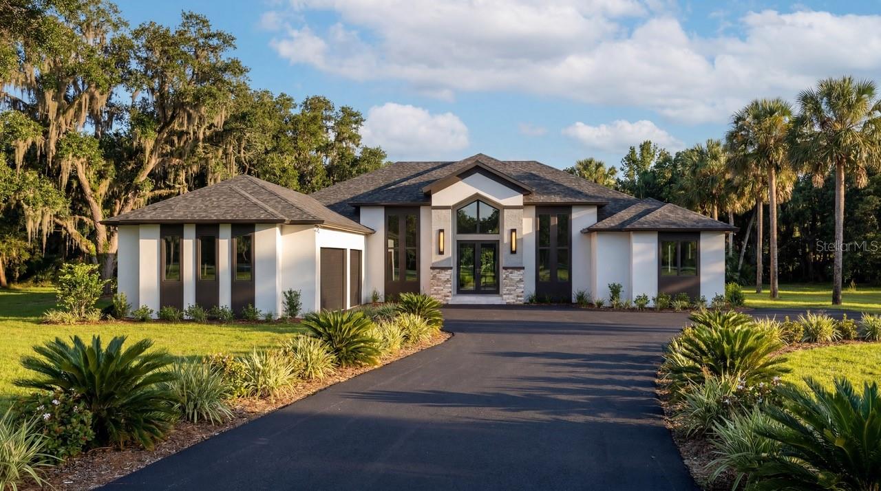 One or more photo(s) has been virtually staged. Under Construction. Nestled within this beautiful gated community the Beauclair Model by McCloskey Homes Inc. redefines waterfront luxury. This exquisite custom residence offers 4,071 sqft of refined living space on 1.5 private acres with 150 feet of direct waterfront on a freshwater canal that opens to the renowned Harris Chain of Lakes. Here, every detail has been thoughtfully curated to create a modern yet warmly inviting sanctuary—perfect for those who seek both sophistication and soulful comfort. ***  Step through the steel front door and experience the foyers' soaring 16ft ceiling that create an immediate sense of grandeur. Rich wood trim and beams add architectural warmth.  The open floor-plan leads to a dramatic great room with inset modern fireplace; built-in features and stunning finishes. The thoughtfully designed layout includes ceiling heights of 10-15ft throughout, four generous bedrooms, four luxurious baths, a dedicated office, and a formal dining room—ideal for both grand entertaining and everyday living. ***  The heart of the Beauclair is its seamless connection to the outdoors. The stunning recreation room features dramatic cathedral ceiling, a full bathroom, a bar with cabinetry, and corner-opening sliders that dissolve the boundaries between inside and out. Open them to transform the space into a breezy, light-filled extension of the travertine deck and sparkling salt-water pool. Just beyond, an outdoor kitchen beckons for al fresco gatherings, complete with ice-maker, high-end grill and beverage centre. Whether hosting sunset soirées or quiet evenings under the stars, this is living that flows effortlessly between refined interiors and breathtaking natural surroundings. *** The gourmet kitchen is a masterpiece of function and beauty, complete with a hidden pantry for seamless organization and storage. Premium integrated appliances and high-end finishes make it a joy for both casual meals and culinary artistry  ***  Boasting 150 feet of shoreline on a peaceful freshwater canal with direct access to the Harris Chain of Lakes, the Beauclair offers unparalleled boating, fishing, and waterfront enjoyment. The expansive 1.5-acre lot provides privacy and space rarely found in today’s market—room for a future dock, lush landscaping, or simply savoring the tranquility. *** Modern in its clean lines and open concept, yet homely in its warmth and liveability, the Beauclair by McCloskey Homes Inc is more than a residence—it is a lifestyle. Built with uncompromising quality and attention to detail, this home is ready to welcome those who appreciate the finer things: privacy, luxury, and a deep connection to Florida’s natural beauty. Located just a few miles from Historic Mt Dora and under an hour from MCO International airport, Disney World and all the best that Central Florida has to offer. You can have it all. Hidden River Lakes – A private, gated enclave known for its serene setting and discerning residents. Offered exclusively through McCloskey Homes Inc. Contact us today to schedule your private preview and make the Beauclair your own.