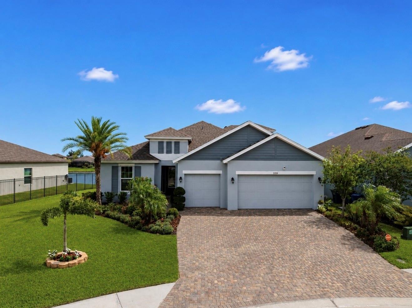 One or more photo(s) has been virtually staged. Welcome to a rare opportunity in the highly sought-after gated community of Trevesta. Perfectly positioned at the end of a quiet cul-de-sac on an oversized, fully fenced homesite, this exceptional Inland Homes Kendal Plus offers the ideal blend of luxury, functionality, and breathtaking waterfront living. From the moment you arrive, you'll be impressed by the long brick paver driveway, three-car garage, and meticulously maintained tropical landscaping that create stunning curb appeal.

Designed to live primarily as a single-story home, this spacious floor plan features 5 bedrooms, 4 full bathrooms, and an upstairs bonus retreat complete with an additional bedroom and full bath—perfect for guests, multigenerational living, a private home office, or media room.

Inside, soaring ceilings and beautiful wood-look tile flooring throughout the main living areas create a bright and welcoming atmosphere. The heart of the home is the gourmet kitchen, thoughtfully designed for both everyday living and entertaining. Features include 42-inch painted wood cabinetry, quartz countertops, a designer range hood, built-in wall oven and microwave, an expansive center island with seating, and abundant cabinet storage. The kitchen flows seamlessly into the spacious great room, making it easy to gather with family and friends while enjoying peaceful water views beyond.


The owner's suite serves as a private sanctuary, offering luxury vinyl plank flooring, generous space, and a spa-inspired en-suite bath featuring dual vanities, a large walk-in shower with multiple shower heads, and a luxurious rain shower experience. Two of the additional secondary bedrooms feature private en-suite bathrooms, providing comfort and privacy for family members or overnight guests.
Step outside and enjoy the serenity of your oversized backyard overlooking tranquil water views—a perfect setting for morning coffee, evening sunsets, or future outdoor living enhancements.

Recent updates include: Custom shiplap built-in fireplace, all new carpeting & fresh paint in the owners suite and flex room.
Residents of Trevesta enjoy an outstanding lifestyle with resort-style amenities including a clubhouse, Resort style pool, state-of-the-art fitness center, splash pad, playgrounds, walking trails, and community gathering spaces. Conveniently located near top-rated restaurants, shopping destinations, golf courses, and some of Florida's most beautiful Gulf Coast beaches, this home offers the best of both luxury living and everyday convenience.
Luxury, space, privacy, and waterfront views—all in one exceptional home. Welcome to 5206 Gavella Cove