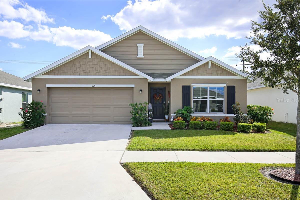 Welcome to this meticulously maintained, like-new home built in 2021, nestled in the charming Brookside Estates community! This 4-bedroom, 2-bathroom, 2-car garage residence is a true gem. The attention to detail is evident from the moment you set eyes on the professionally landscaped yard, complete with an irrigation system and fenced backyard. Step inside to discover a home adorned with pristine ceramic tile flooring throughout. The spacious entryway boasts not one, but two closets, offering ample storage space for your convenience. The thoughtfully designed split bedroom floorplan situates all secondary bedrooms towards the front of the home, each boasting generously sized walk in closets. The secondary bathroom features a single sink vanity and a tub/shower combination. Towards the back of the home the open great room awaits. The kitchen is a chef's dream, equipped with granite countertops, a convenient island with a breakfast bar, pendant lights, a walk-in pantry, and top-of-the-line stainless steel appliances. Adjacent to the kitchen, the dining room offers slider access to the covered lanai, which extends to an inviting pergola and a built-in grill, perfect for outdoor entertaining. Tucked in the back of the home, just off the Living room is the primary bedroom, providing a serene retreat. The primary bedroom is complemented by an en-suite bathroom, featuring a dual-sink vanity, a shower stall, a water closet, and not one, but two closets—one of which is a spacious walk-in. Brookside Estates is perfectly located in Ruskin, a town known for its quaint charm and its convenient proximity to lively metropolitan hubs like Tampa, Bradenton, and Sarasota. Its strategic positioning provides effortless access to major routes including I-75, Hwy 301, and Hwy 41, ensuring convenient commuting for residents.