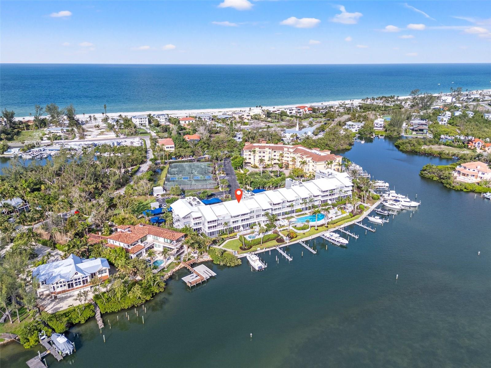 Paradise at Harbour Villa Club – Waterfront Luxury with a boat slip on Longboat Key! Enjoy this condo year round, or rent it weekly when you cannot be there- you choose! Discover this fully renovated 2BR/2BA condo with panoramic views of the gorgeous Sarasota Bay.  Bright and spacious, the open floor plan features soaring 9 ft ceilings, custom finishes, a gourmet kitchen with top-of-the-line appliances and a sleek wet bar. The primary suite offers stunning water views, dual closets, and a spa-inspired bath. The second bedroom is spacious and set apart from the primary. Step into the enclosed lanai for breathtaking 180° water views  and added living space— perfect for relaxing or entertaining. This unit comes with a deeded 40' boat slip #3 which features upgraded power and plumbing, new wraps, caps, marine grade bumpers and a  deck box- a rare bonus that can accommodate a 55' vessel! Harbour Villa Club is nestled in a quiet corner and you can walk or bike to the beach, area restaurants, and beloved Harry's Corner Store. This is a pet friendly community with covered parking, storage, elevators, kayak and bike storage, private dock, heated pool, tennis/pickleball courts, grills and beautiful landscaping.   Weekly rentals allowed.  Call today!