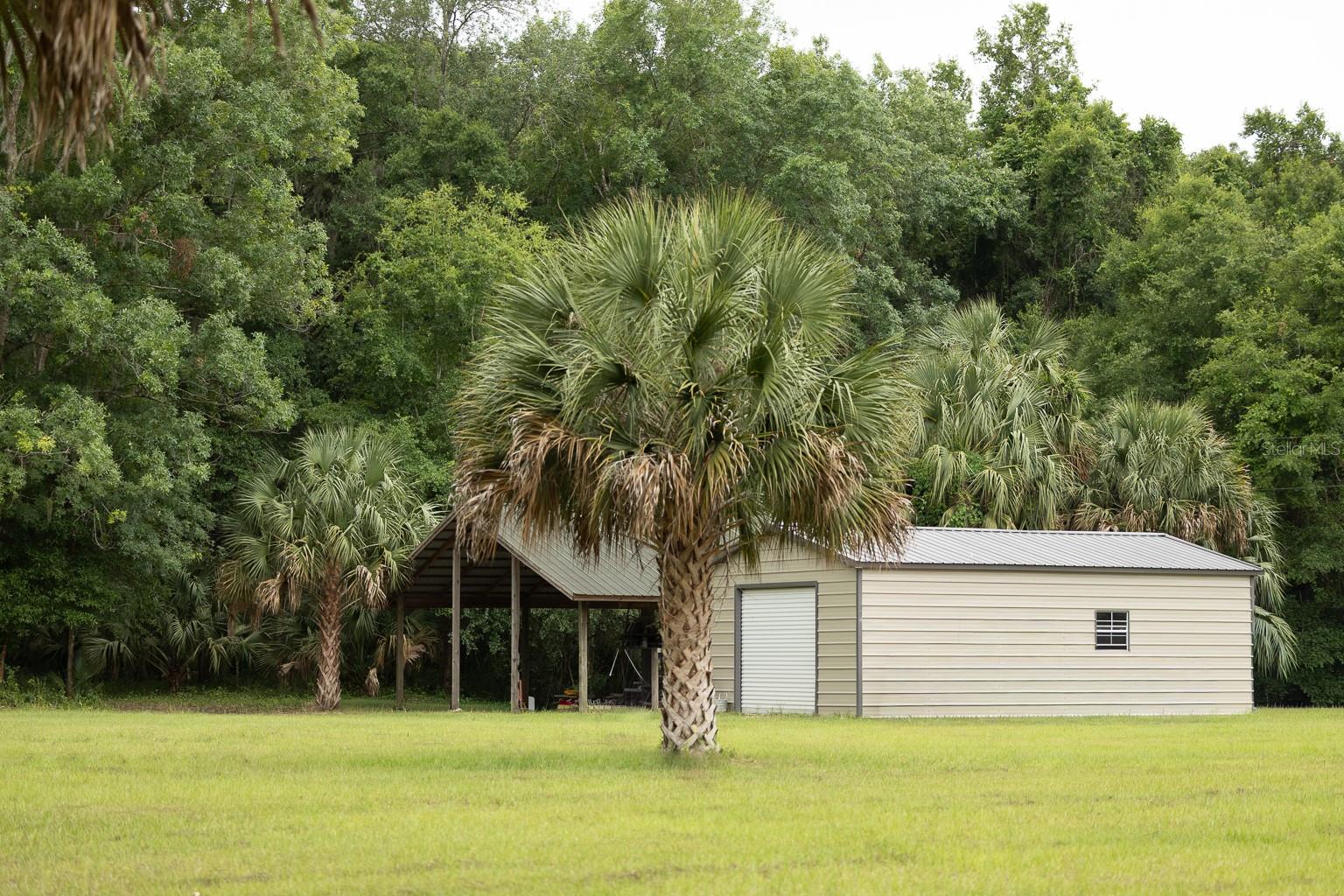The ultimate homesite is at your fingertips! Spanning over 12.25 acres of true Old Florida, this beautiful tract features mature oak canopies, lush orange trees, open pastures, and dense wooded areas. Bordering more than 870 feet of conservation land within the Orange Creek Conservation Area, the property is surrounded by abundant wildlife including trophy Whitetail deer, Osceola turkey, and other native game.
Improvements include active power service, a functional well, pre-existing septic system, a 2023-built 30’x35’ steel building, and a 35’x23’ pole barn. Conveniently located with quick access to US HWY 301, the property sits centrally between Ocala and Gainesville, while being just minutes from some of Florida’s premier bass fishing destinations including Orange Lake and Lochloosa Lake.
Several world-renowned springs are also nearby, including Salt Springs Recreation Area, Juniper Springs Recreation Area, and Silver Glen Springs. For those with equestrian roots, many of Ocala’s premier equestrian venues are within a 30-minute drive. Whether you are seeking a private homesite, recreational retreat, or future investment, this property is sure to impress.