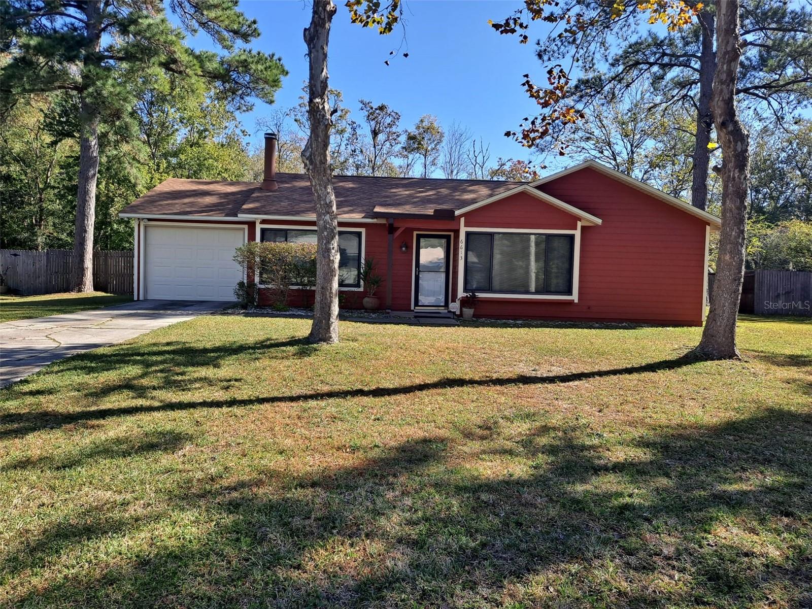 Don't miss this opportunity to own an affordable home in Northwood Pines with NO HOA fee.  this desirable 3 bedroom 2 bath home features tile floors in the living room and kitchen, laminate in all the bedrooms; NO CARPET! New dishwasher & range.  The natural wood fireplace in the living room makes it a cozy place for the evenings. New ceiling fans in all areas.  The primary bedroom offers an updated en-suite bath with a walk-in closet. Roof replaced in 2020. screened back porch with shades is spacious looking over a huge fenced backyard which can be a garden lover's favorite spot. Look no further and welcome home!