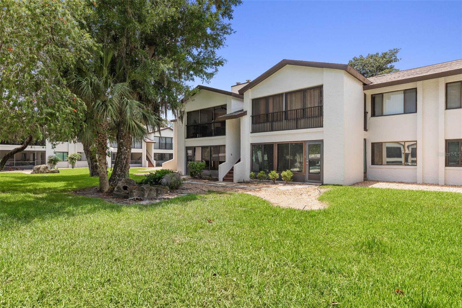 This awesome, well maintained ground floor unit in 55+ community is in the heart of Ormond near The Trails Shopping center, restaurants, Publix and beaches. This spacious 2-bedroom condo features luxury vinyl flooring throughout, and tiled floors in the screened porch which overlooks the sparkling community pool. You'll love the beautifully updated kitchen, which has been upgraded with new cabinets and newer appliances. A cozy fireplace adds ambiance and comfort on chilly nights. Park your car in your designated covered parking space with an adjoining storage room. These units are in high demand, so don't wait or it will be gone!