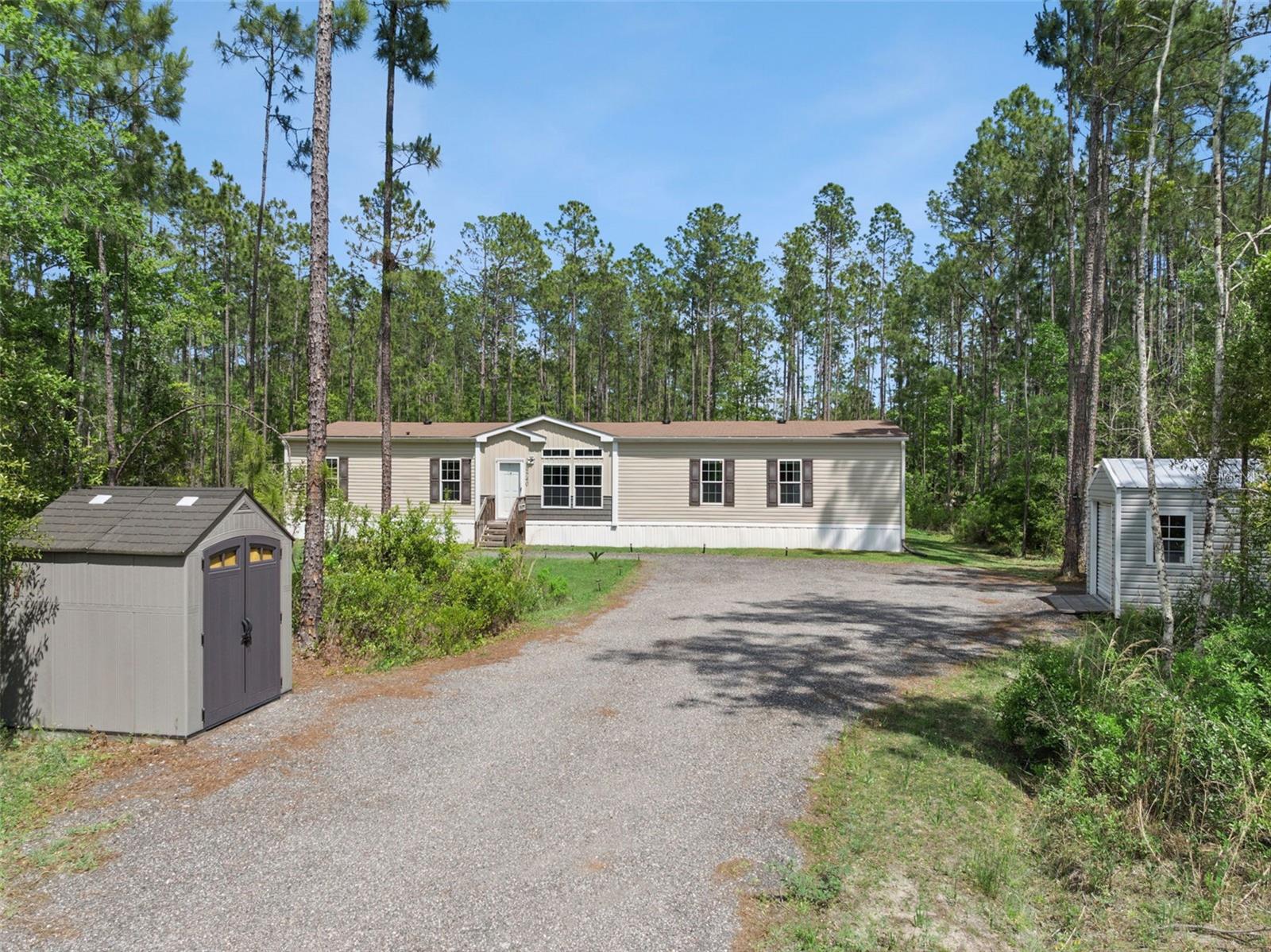 Welcome to 9740 Ebert Ave! Where there’s room for the family, the toys, the cookouts… and yes, the pool parties too! Nestled at the beginning of Flagler Estates, this practically brand-new 2022 manufactured home offers 5 bedrooms, 3 bathrooms, and over 2,400 sq ft of inviting living space. Inside, you’ll find the perfect blend of comfort and functionality, while outside you’ll love the spacious yard and refreshing above-ground pool ready for endless Florida summers. 1 utility shed and 2 personal storage sheds convey with sale. Located on fully asphalt roads and just minutes from local shopping, gas stations, and everyday conveniences, you can enjoy peaceful country living while staying only 20 minutes from the city buzz. Bring the boats, four-wheelers, family, and friends — this is the kind of home memories are made in! Call/txt Agent or Showingtime to tour.