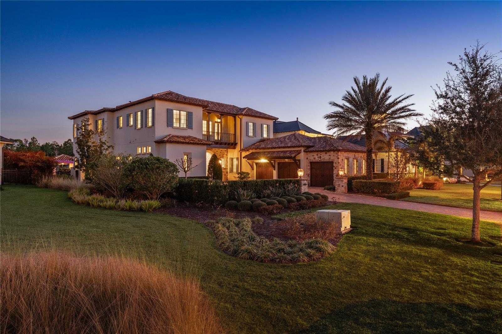 Located in Golden Oak at Walt Disney World® Resort, Covina is a masterfully crafted
estate that redefines luxury living, offering an extraordinary and immersive lifestyle just
moments from the magic of Walt Disney World. Upon arrival, the home makes a striking
first impression with its refined façade and elegant entry, leading into a breathtaking
living space defined by soaring ceilings, exposed wood beams, and windows that flood
the home with natural light. The chef’s kitchen is both a visual centerpiece and a
functional masterpiece, featuring expansive countertops, custom cabinetry, and top of
the line appliances. A beautifully designed butler’s pantry enhances the space,
providing discreet storage and prep areas perfect for hosting intimate gatherings or
large-scale celebrations. The primary suite is a true private retreat, overlooking the
serene pool and glistening pond. This tranquil sanctuary offers a spa-like bathroom with
dual vanities, a large soaking tub, an oversized walk-in shower, and an expansive closet
with a center island, designed with boutique-style elegance. Upstairs, a spacious loft
creates a secondary living area ideal for relaxing or entertaining, while three generously
sized ensuite bedrooms provide private havens for family and guests alike. A second
laundry room on this level adds a layer of convenience that enhances everyday living.
Adding to the home’s exclusivity is a separate guest casita, offering a luxurious and
private retreat for visitors. This home is fully equipped with a state-of-the-art Crestron
smart home system, integrating surround sound, security cameras, lighting, and climate
control, along with a private elevator that seamlessly connects each level. Outdoor living
rivals the finest resorts. A large, covered lanai with retractable screens and a full
summer kitchen opens to a spectacular pool and spa with a dramatic swim-up bar, all
framed by tranquil pond views that create a serene, private oasis. Residents of Golden
Oak enjoy an unparalleled resort-style lifestyle with access to their own private
clubhouse, the iconic Summerhouse, and the world-renowned Four Seasons Resort
Orlando, featuring an 18-hole championship golf course, full-service spa, and an
exceptional collection of luxury dining experiences, creating a lifestyle that is as
extraordinary as the home itself.