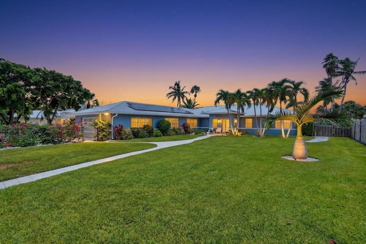 Welcome to one of Lido Key's finest waterfront residences, where impeccable craftsmanship, sophisticated design, and an uncompromising renovation have created a home unlike anything else on the market. Perfectly positioned along the coveted canal on prestigious N. Polk Drive, this extraordinary estate has been completely rebuilt and remodeled from the studs up, delivering the quality, finishes, and attention to detail discerning buyers expect in today's luxury market.

Designed for both elegant entertaining and effortless everyday living, the thoughtfully crafted floor plan features 3 spacious en-suite bedrooms, each with custom designer closets, including a spectacular primary suite occupying its own private wing of the home. The luxurious primary retreat also enjoys direct access to a private screened lanai, creating the perfect sanctuary to enjoy peaceful waterfront mornings and evening sunsets. Additional living spaces include two dedicated offices, a media room, formal dining room, and an inviting family room centered around a stunning Dimplex fireplace showcased by a custom faux-stone feature wall.

The heart of the home is the completely reimagined chef's kitchen, where modern elegance meets exceptional functionality. Custom cabinetry is complemented by quartz countertops throughout, a striking oversized custom waterfall edged island features a Kohler ceramic farmhouse sink with designer gold fixtures, premium Bosch induction cooktop, oven and microwave, stainless designer range hood with specialty lighting, dual Zephyr beverage refrigerators, and high-end finishes that rival luxury designer expectations.

Every detail throughout the residence has been carefully curated, from the custom designer closet systems and motorized blinds and shutters from Shutters of Elegance to the refined architectural finishes that elevate every room.

Step outside to your own private waterfront oasis. Completed in 2022, the spectacular resort-style pool features both a heater and chiller and is surrounded by expansive travertine pavers, creating the ultimate outdoor entertaining space. The waterfront improvements are equally impressive, including a brand-new seawall (2025) with approximately 121 feet of waterfrontage and 70 linear feet, new pilings with integrated solar lighting, and professionally designed Arbor Landscaping completed in 2025-2026, creating breathtaking curb appeal worthy of a California coastal estate.

Set on one of Lido Key's most prestigious waterfront streets, this exceptional property offers direct canal access while being just moments from the world-renowned white sands of Lido Beach, St. Armands Circle's upscale boutiques and restaurants, downtown Sarasota, and the city's celebrated arts and cultural attractions.

This is more than a luxury home, it's a complete architectural transformation where every finish, every material, and every design element has been executed to the highest standard. Homes renovated to this caliber are exceptionally rare. This is the definition of modern waterfront luxury on Lido Key.