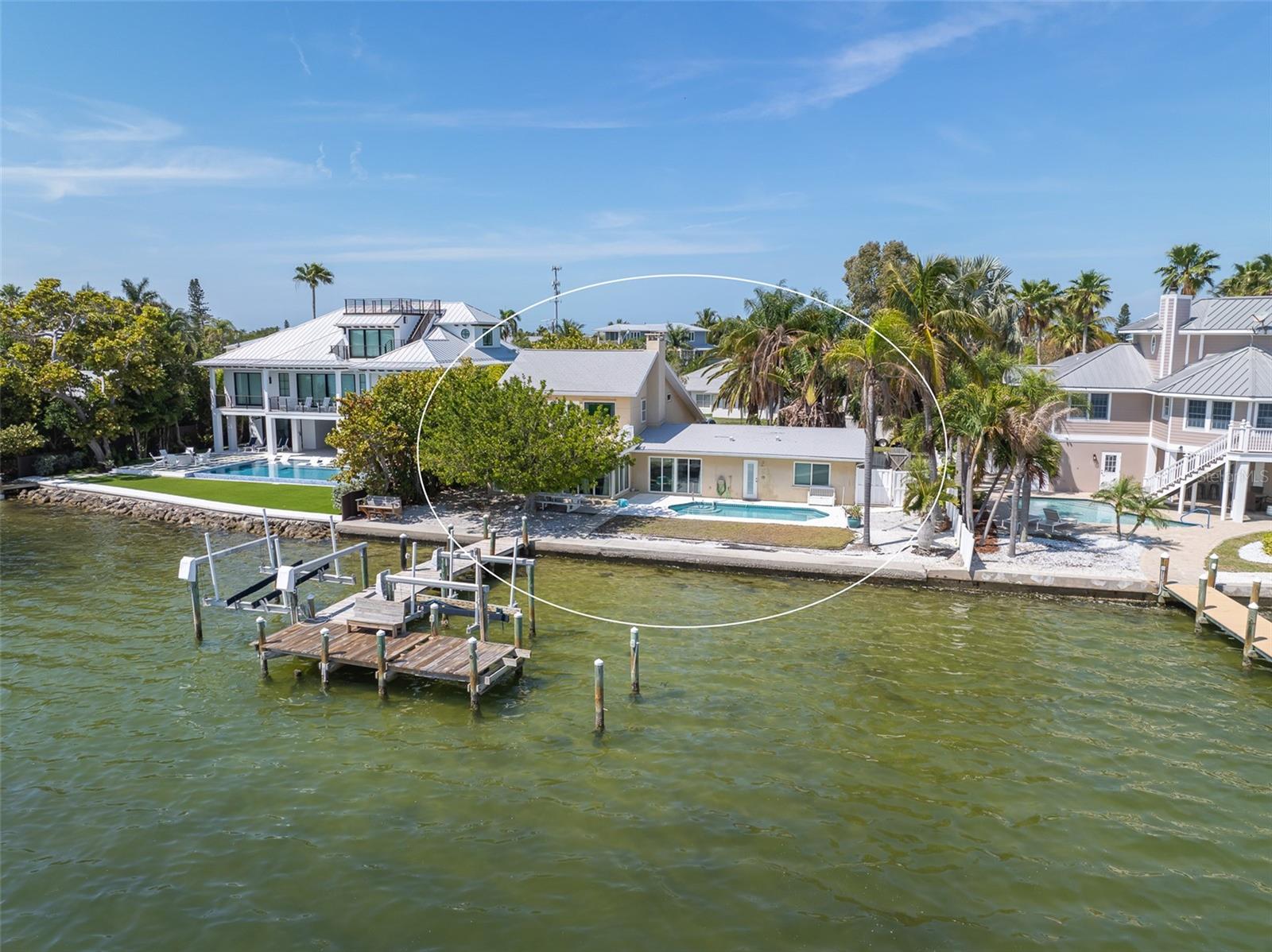 Great location WATERFRONT home centrally located in the heart of Holmes Beach on a quiet street on Anna Maria Island!! 90 feet of waterfront with gorgeous views!!!  There is a home on the property, but selling for lot value only.  Build your dream home and add your own finishes and personal style!  Imagine waking up to the beautiful sunrise every morning! Nature is right in your backyard, watch dolphins jump around and manatees swimming by. These lots on deep water are hard to come by!  Don't miss this rare opportunity with many possibilities with this property.