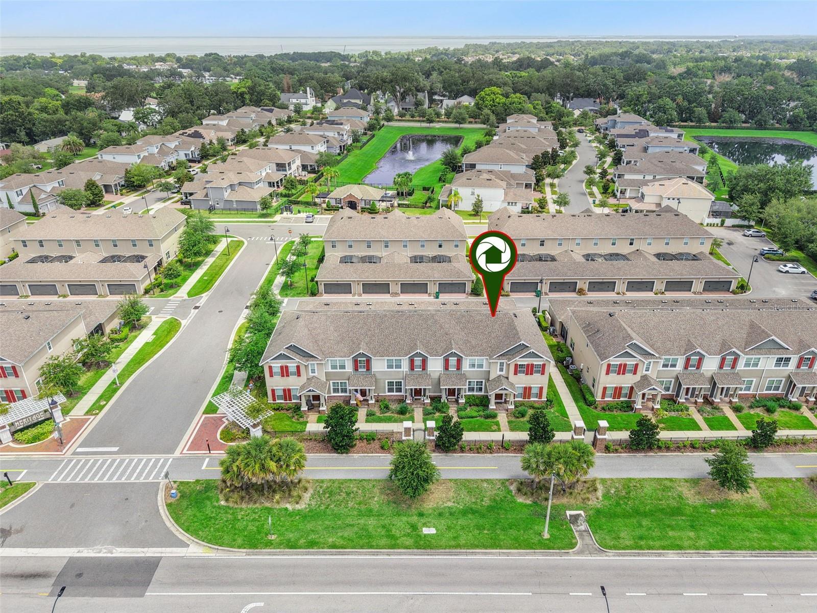Experience the Best of Downtown Winter Garden Living!!!

Perfectly positioned in the highly sought-after Heritage at Plant Street, this exceptional corner-unit townhome offers the ultimate blend of luxury, convenience, and low-maintenance living—all within Winter Garden's coveted Golf Cart District and with direct access to the acclaimed West Orange Trail.

Built in 2018 by M/I Homes and lovingly maintained by its original owners, this beautifully upgraded 3-bedroom, 2.5-bath residence with a 2-car epoxy-finished garage showcases thoughtful design, premium finishes, and one of the community's most desirable locations. The HOA covers exterior maintenance—including the roof and landscaping—so you can enjoy a carefree lifestyle.

The coveted corner location offers abundant natural light, added privacy, a grassy side yard perfect for pets or play, and guest parking just steps from the front door.

Inside, the popular Windham II floor plan features soaring ceilings, an open layout, and a bright flex room ideal for a home office, playroom, or second living area.

The designer kitchen impresses with GE Profile slate appliances, a natural gas cooktop, stacked convection wall oven and microwave, 42-inch cabinetry, Silestone countertops, tile backsplash, under-cabinet LED lighting, and an oversized island with breakfast seating. It opens seamlessly to the dining area and great room, where corner windows fill the space with natural light. Large-format ceramic tile runs throughout the first floor.

A spacious laundry room with a full-size washer and gas dryer, plus oversized under-stair storage, adds everyday convenience.

Upstairs, the private owner's suite features a walk-in closet and an elegant bath with a dual Silestone vanity and a tiled walk-in shower with seamless glass enclosure. Two additional bedrooms share a stylish full bath with coordinating finishes.

French doors with built-in blinds lead to your private screened brick-paver courtyard with covered and open seating areas overlooking the grassy side yard. The rear-entry garage includes screened sliders that create a refreshing cross breeze into the courtyard.

Additional upgrades include ENERGY STAR® Low-E windows, energy-efficient HVAC, whole-home water softener and conditioner, under-sink instant hot water, premium whisper-quiet ceiling fans with remotes, faux wood blinds, and a timeless neutral interior palette. The townhome was used as a second/vacation home so can be sold fully furnished!!!

Residents enjoy a community pool and dog park, all just minutes from the award-winning restaurants, boutiques, breweries, farmers market, and year-round events of historic Downtown Winter Garden.

Rarely does a corner-unit home of this caliber become available. Enjoy designer upgrades, abundant natural light, and true lock-and-leave convenience in one of Central Florida's most desirable downtown communities. Hop on your golf cart, explore the West Orange Trail, and experience the vibrant Winter Garden lifestyle.