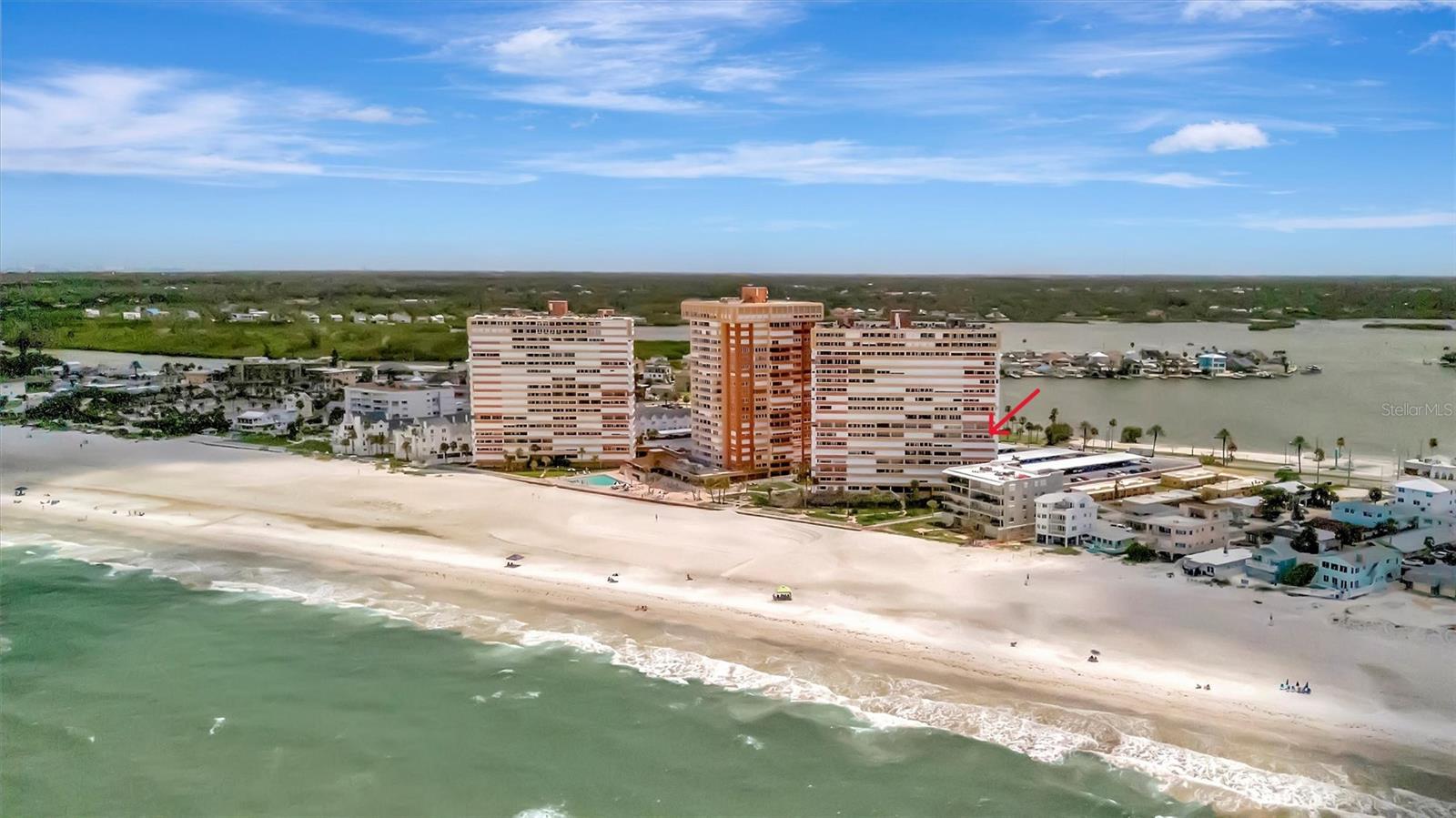 Experience coastal living in this rare southwest corner unit in Redington Towers, a Gulf-front, guard-gated community in Redington Shores. This two-bedroom, two-bath condo offers panoramic water views of both the Gulf of Mexico and the Intracoastal Waterway, with the unique ability to enjoy both sunrise and sunset views from three private balconies. Filled with natural light, the open-concept layout features a spacious living and dining area, a kitchen with granite countertops, stainless steel appliances, abundant cabinetry, and a breakfast bar, plus a flexible nook ideal for a home office or additional dining space with water views. The primary suite offers private balcony access, an updated ensuite bath, and generous closet space, while the second bedroom includes a Murphy bed and functions well as a guest room or office. Additional features include impact-rated sliding glass doors, storm shutters, and two assigned under-building parking spaces, a rare and valuable feature. Redington Towers is a secure, 24-hour guard-gated community with direct private beach access, a heated beachfront pool, EV charging stations, and storage for kayaks, paddleboards, and bicycles, with a community center currently being restored to include a fitness center, clubhouse, and social spaces. Located just minutes from restaurants, shops, and parks including Boca Ciega Millennium Park, with easy access to the beach trolley, Treasure Island, John’s Pass Village, and Clearwater Beach, and approximately 45 minutes to Tampa International Airport. This property is ideal as a primary residence, second home, or vacation retreat. Schedule your private showing today to experience Gulf-front living in Redington Shores. This southwest corner condo offers Gulf and Intracoastal views, three balconies, under-building parking, and a secure guard-gated beachfront community.