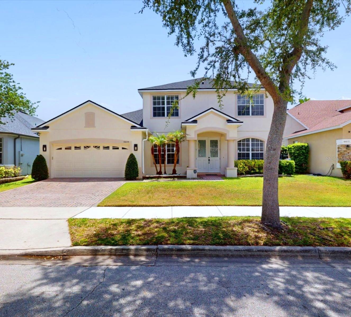 FALL IN LOVE AT FIRST SIGHT! From the moment you step inside 6609 Lake Pembroke Place, you’ll instantly feel right at home. Tucked away in the highly sought-after Vista Lakes/Lee Vista community, this beautifully renovated 4-bedroom, 3-bathroom gem strikes the perfect balance between modern style and effortless, comfortable living. With its bright, open-concept design, gorgeous marble floors, and a sleek glass rail staircase that adds just the right amount of contemporary flair, this home is completely turn-key and ready for you to move right in.

The Main Level & Design Details:
The spacious main floor flows beautifully from room to room, highlighting the stunning marble tile flooring downstairs. The kitchen is an absolute standout, boasting premium natural stone countertops throughout that extend into the bathrooms. As a huge bonus, all kitchen appliances, as well as the washer and dryer, are included. Head upstairs via the striking modern glass rail staircase with sleek metal trimmings to find beautiful, solid hardwood flooring running through all the bedrooms (no carpet!).

An Outdoor Oasis for Family & Friends:
Step outside into your private retreat. The large, screened-in lanai features premium travertine flooring, creating the perfect spot for weekend BBQs, relaxing evenings, and getting together with family and friends. The entire backyard is fully enclosed with a durable, stylish aluminum fence, offering plenty of space and peace of mind.

Peace of Mind & Resort-Style Living:

Move-In Ready: Meticulously maintained and completely updated.

New Roof: Installed in May 2023.

Amazing Community Amenities: Living here gives you access to a resort-style pool, tennis courts, a fitness center, playgrounds, parks, and even a private boat ramp with lake access for fishing and weekend recreation.

Unbeatable Location: Enjoy a breeze of a commute with easy access to SR 417 and SR 528. You are just minutes away from the Orlando International Airport, Lake Nona, Medical City, top-rated schools, and all the shopping and dining at Lee Vista Promenade.

This pristine property truly has it all—style, location, and community. Schedule your private showing today and welcome home!