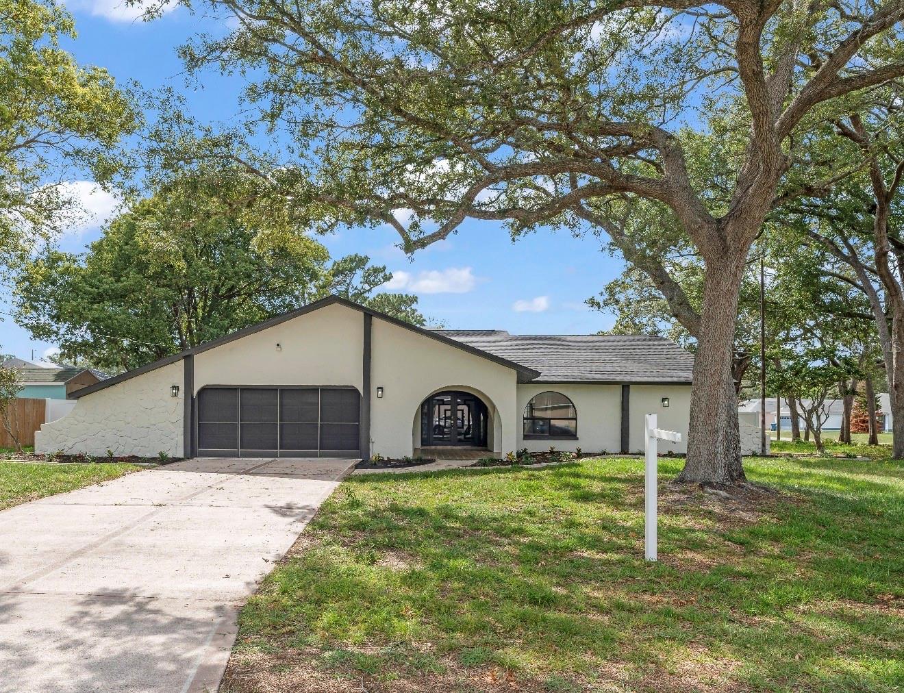 Beautifully renovated 3-bedroom, 3-bath pool home situated on a desirable corner lot in Spring Hill. This move-in-ready home has been completely remodeled with high-end finishes and thoughtful attention to detail throughout, and features a brand-new roof installed in 2026.

Offering approximately 1,890 square feet of living space, this contemporary residence showcases an open-concept floor plan, split-bedroom layout, and high ceilings that create a bright and inviting atmosphere. Interior highlights include a stunning floor-to-ceiling wood-burning fireplace, ceiling fans, a spacious primary suite featuring dual walk-in closets, and a chef-inspired kitchen with an eat-in dining area. The oversized 2-car garage offers extra width and abundant storage space, providing flexibility for vehicles, tools, equipment, and more.

The gorgeous kitchen showcases quartz countertops, modern cabinetry, ample storage, an oversized quartz island that serves as the centerpiece of the space, and brand-new appliances. Designed for both everyday living and entertaining, it offers abundant seating, workspace, and the perfect setting for gathering with family and friends. High-quality laminate flooring runs throughout the entire home, providing both style and durability.

Enjoy Florida living at its finest with a screened rear lanai overlooking a private in-ground pool with a newly rescreened enclosure and pool heater, perfect for year-round enjoyment. The fully fenced backyard offers privacy and plenty of space for pets, play, or outdoor entertaining.

Conveniently located near shopping, dining, medical facilities, parks, and major roadways. No HOA and no lease restrictions.

A beautifully updated home offering the perfect combination of comfort, style, and convenience. This beautifully remodeled home truly has it all. Don’t wait—schedule your showing today before it’s gone! 

Certain Photos may include virtual staging or digital enhancements for illustrative purposes only.