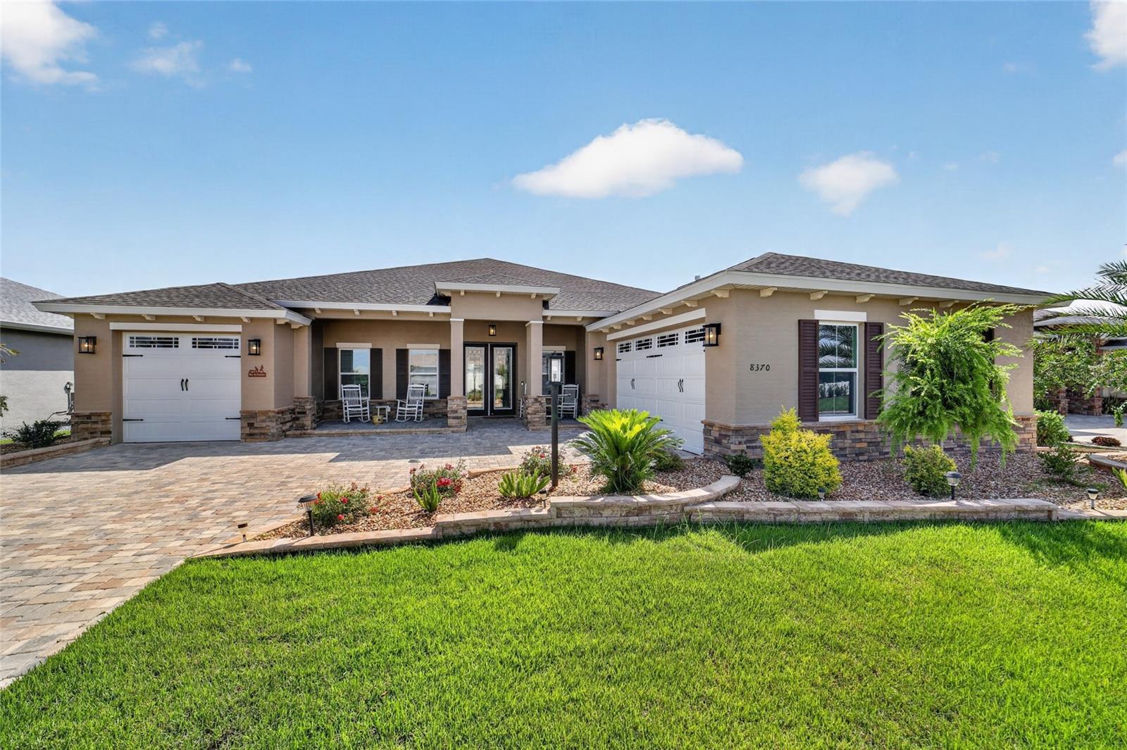 Welcome to this stunning Aberdeen model, beautifully situated on a private homesite with no rear neighbors, offering peaceful views of a dry retention pond from the comfort of your finished enclosed lanai and expansive paver courtyard patio. With nearly 2,900 square feet of thoughtfully designed living space, this exceptional residence combines luxury, privacy, and timeless elegance. 
Inside, you'll find 3 spacious bedrooms, a flex room, 3 full bathrooms, and a desirable split 3-car garage configuration. Luxury vinyl plank flooring flows seamlessly throughout the home, while tray ceilings in the foyer, great room, and primary suite, complemented by crown molding throughout, create an atmosphere of sophistication. 
The heart of the home is the impressive gourmet kitchen, designed for both everyday living and entertaining. It features elegant white soft-close cabinetry with crown molding, quartz countertops, an upgraded designer backsplash, stainless steel appliances, and an oversized center island showcasing contrasting dove gray cabinetry with matching quartz countertops—providing abundant prep space, seating, and style. 
The luxurious primary suite is a true retreat, offering two oversized walk-in closets with custom built closets and a spa-inspired ensuite bath with dual vanities and generous space to unwind. Guests will appreciate the private second ensuite bedroom, ideal for extended family or multigenerational living. A separate wing of the home features the third bedroom and full bath, creating the perfect space for overnight guests, a hobby or craft room, media room, or home office. 
Outdoor living is equally spectacular. Relax year-round in the enclosed lanai or entertain on the massive paver courtyard patio with built in electrical lights, where you'll enjoy tranquil views and exceptional privacy with no rear neighbors. 
Car enthusiasts and hobbyists alike will love the split 3-car garage, featuring an attached two-car garage with epoxy coating  plus a separate single-car garage—ideal for additional storage, a golf cart, workshop, or hobby space. 
From the moment you arrive, the curb appeal is undeniable with raised landscape beds, professionally upgraded landscaping, a paver driveway, and an attractive stone-accented exterior that sets this home apart.   This home also offers a water filtration system.
Candler Hills is the estate section of On Top of the World.  On Top of the World is Ocala's premier 55+ golf course resort community with golf cart access to shopping, dining, entertainment, banking, health, and beauty.