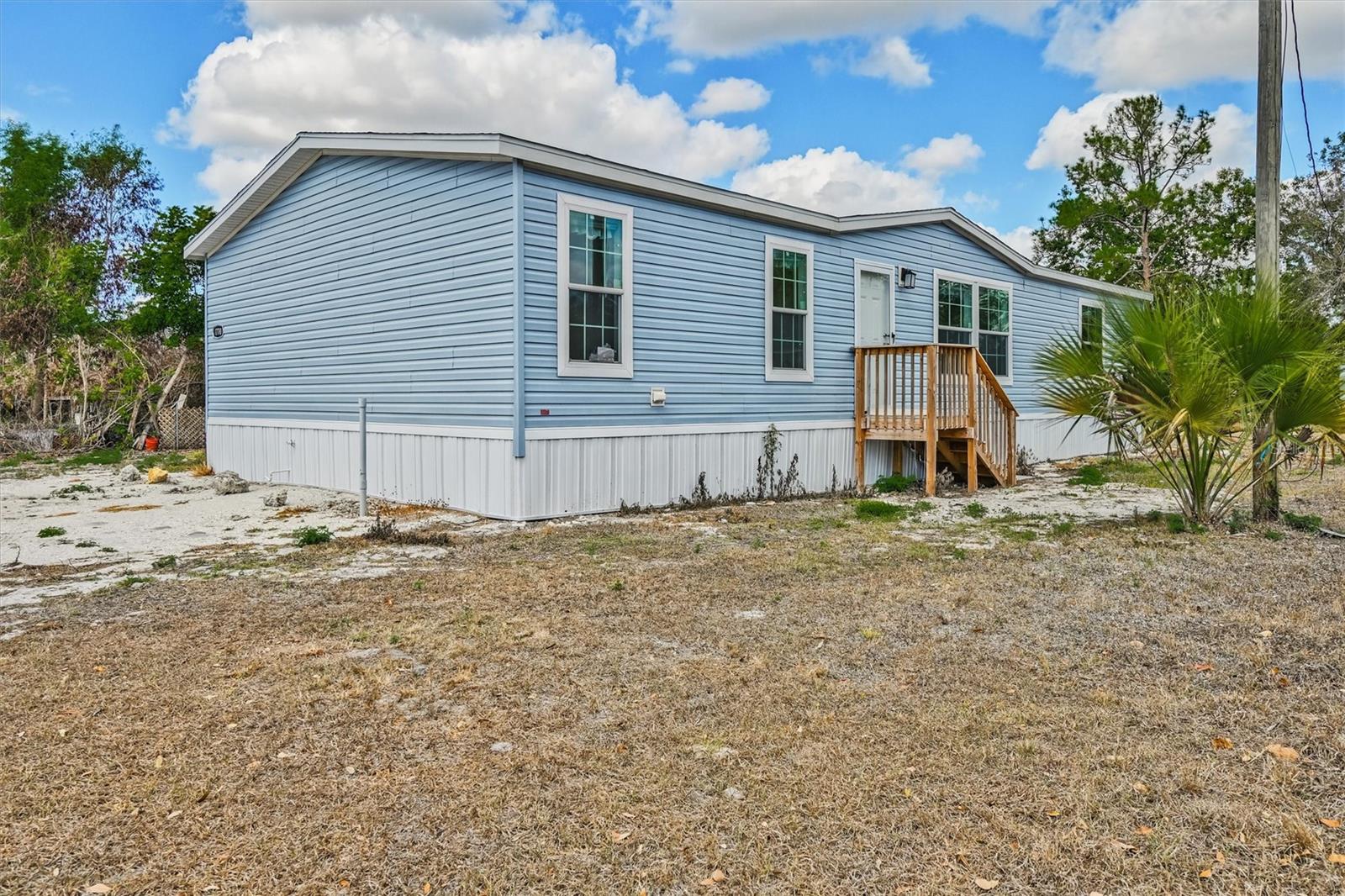 Check out this 2025 built double wide mobile home located on half an acre of land. This home features an Island kitchen with Whirlpool Stainless appliances, wood cabinetry & tile backsplash. Crown molding in living room, dining room, kitchen and master bedroom. Dining room has sliding glass doors that lead to wooden stairs. All three bedrooms include a walk in closet. Spacious master suite includes a large Master bath with shower only. Inside Utility room off the kitchen with door leading to wooden stairs. This property is conveniently located to shopping and dining. Also, Easy access to highway I75. This home would make for a great investment property, check it out today!