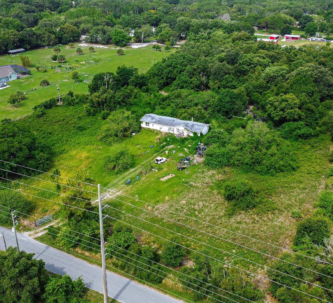5.47 ACRES TO BUILD YOUR DREAM HOME OR PERFECT INVESTMENT FOR DEVELOPMENT! A great investment opportunity for developers and builders! Here is your great chance to own this land that is high and dry in Saint Cloud! If you are looking for land to build on and develop here in Osceola County, then you found the right property!  The VALUE IS IN THE LAND ONLY. This property boasts five and a half acres of land, that has future zoning for low density residential development.  The future use of this land will allow three to eight homes for each acre according to Osceola County Zoning. All information is deemed accurate and provided from public records. Room measurements are estimated.   Do not approach the property without a licensed real estate agent as appointments are required. The letter from the county and the code is available upon request. The property is only 15 minutes to Downtown Saint Cloud, 30 minutes to the Orlando International Airport, and 1 hour to Melbourne beaches! We have a reasonable reach of the local toll roads for traveling to work or other needs as the 417 is approximately 25 minutes away off of Narcoossee Road and the Florida's Turnpike is off of hwy 192 heading west through Saint Cloud which we can reach in about 30 minutes! Don't forget Orlando's theme parks too! This location offers so much for homeowners and the developer who plans to invest in it. Now is your chance to take part of the rapidly developing East side of Saint Cloud and close to the growing Lake Nona area! Hackney Road is situated off of Narcoossee Road in an area that is surrounded with amazing nature and a peaceful setting. Buyers are to do their due diligence on the intended use and know this is for investment opportunity!  Sold AS IS and the mobile home does NOT have added value and is NOT accessible for viewing. Only the land is to be viewed where accessible by appointment only. There are currently two areas of new homes being developed nearby with known home builders; one is at the end of Hackney Road and the other is at the end of Ralph Miller Road.