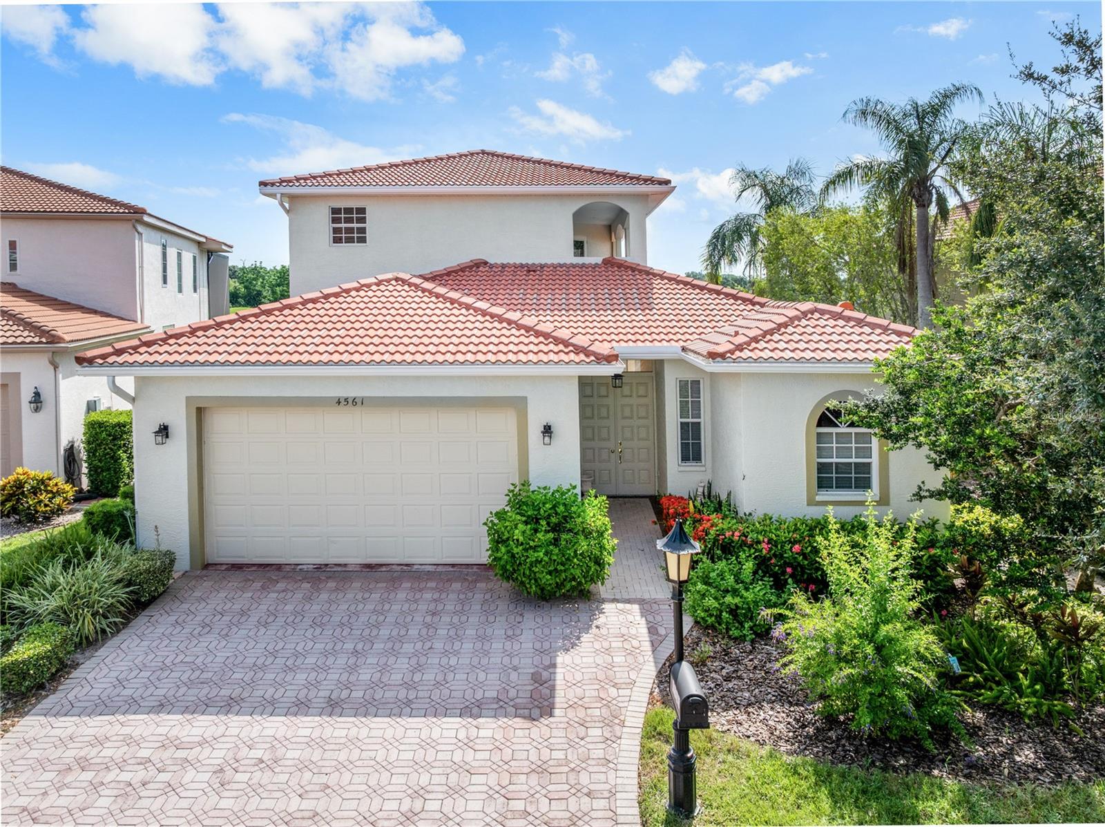 Virtually Staged. This is an unfurnished 4 bedroom, 4 and a half bathroom villa with an upstairs office and golf course and water views located in the gated Prestancia community on Palmer Ranch in Sarasota! The two-story villa features a paver driveway leading to a 2-car garage, Mediterranean-style architecture, and an open floor plan finished with diagonally-laid tile and engineered wood flooring, crown molding throughout, and a custom wrought iron and wood staircase. A private screened courtyard sits at the center of the villa, separating the main residence from a self-contained guest suite, or casita, that opens directly onto the courtyard. The kitchen features dark granite countertops, antique-white glazed solid wood cabinetry, a diagonal tile backsplash, plantation shutters over the sink, and a center island with a prep sink and breakfast bar. Appliances are black including a built-in double wall oven, cooktop and microwave, with a panel-front side-by-side refrigerator. The main living area is anchored by a great room with floor-to-ceiling built-in shelving and cabinetry and a wall of French doors that look out to the rear of the home, where the golf course and water sit just beyond. A separate dining area with an arched transom window adjoins a wet bar with a wine refrigerator. The owner's suite is on the ground floor and includes dual walk-in closets. The en-suite master bathroom has a jetted garden tub with a granite surround, a separate glass-enclosed walk-in shower, dual vanities, and a private door to the courtyard. The remaining bedrooms include the courtyard casita, which has its own full bathroom with a walk-in tiled shower, and two upstairs bedrooms, each with a private en-suite bathroom with a tub/shower combination. The upstairs office has engineered wood floors and opens to a private balcony overlooking the grounds. There is also a half bath near the wet bar for guests. The interior laundry room includes a washer and dryer, a utility sink, and overhead cabinetry. The screened courtyard is finished with decorative terracotta tile and features a built-in grill, and the home backs to the water and golf course. Prestancia is a guard-gated community in the heart of Palmer Ranch, built around TPC Prestancia and its two championship golf courses. The 35,000-square-foot clubhouse offers dining, and optional golf and social memberships are available directly through the club, though no membership is required to live in the community. Residents enjoy tree-lined streets with lake and golf course views, mature landscaping, and sidewalks for walking and biking. Please allow up to 3 weeks after lease signing for community approval before move-in. The home is close to the Legacy Trail and a short drive to shopping and dining around the Sarasota Square area, including Costco, Publix and Target, as well as the YMCA. If an application doesn't score high enough, the resident may be required to place the equivalent of two months' rent in a security deposit. Please be aware that leasing this property includes a non-optional Home Assistant Services Package that will cost an additional $39 per month. These services and their cost are separate from Tenant's monthly rent payment and all other payments described in the Lease or any separate Lease addendums. The Home Assistant Services offered are described in the Resident Welcome Packet which can be viewed on our website at Sarasota Management