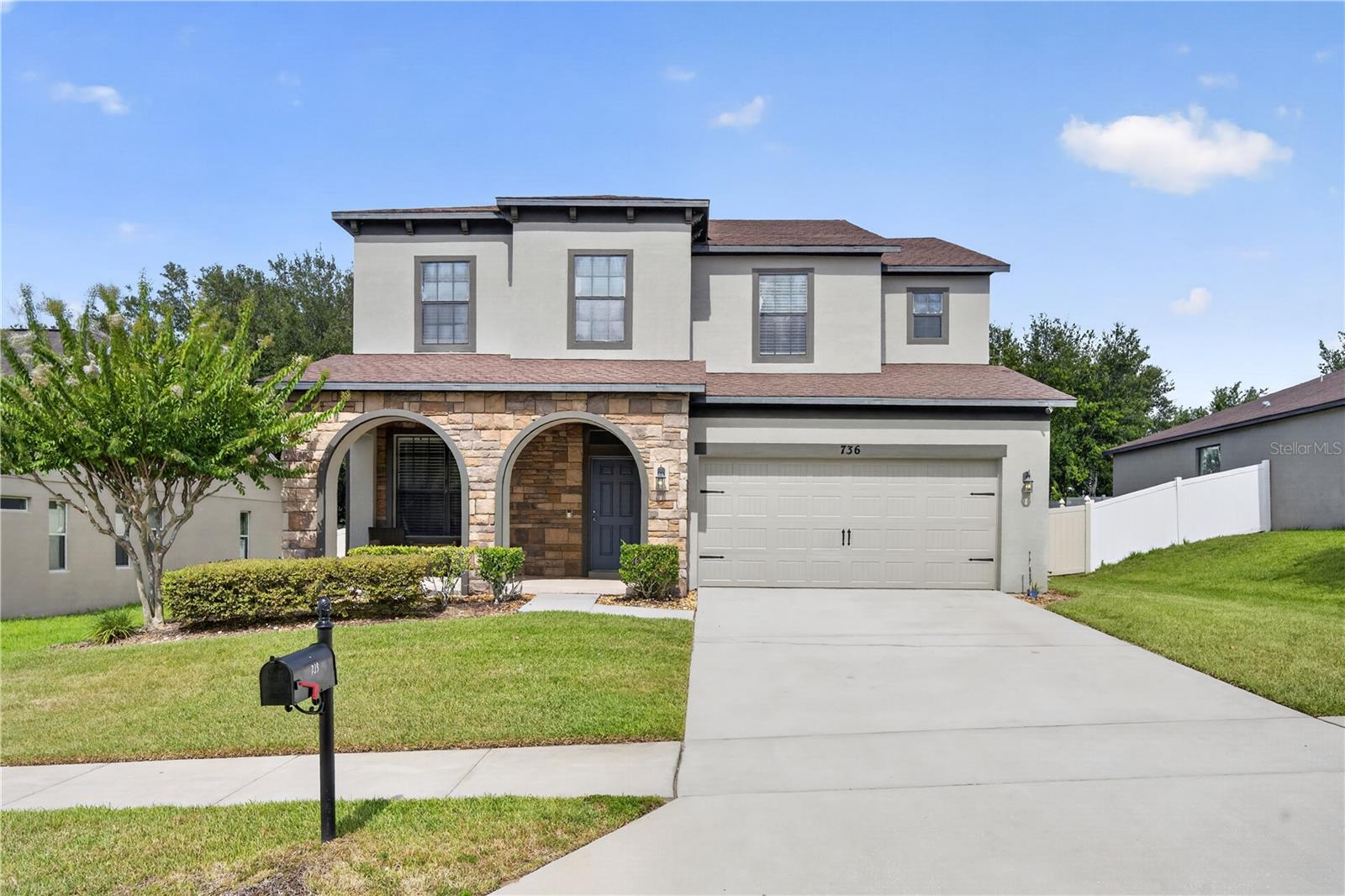 Welcome to 736 Woods Landing, where space, style, and convenience come together in one of Minneola's most sought-after communities. Perfectly situated on an oversized homesite, this beautifully maintained Somerset model offers exceptional upgrades, thoughtful design, and room for everyone.From the moment you step inside, you'll appreciate the light-filled interior, elegant finishes, and functional floor plan. A formal dining room and convenient half bath greet you at the front of the home, creating the perfect space for hosting family gatherings and special occasions. In the heart of the home is the expansive great room, seamlessly connecting to a large kitchen designed for both everyday living and entertaining. Featuring 42-inch cabinetry, stainless steel appliances, a natural cooktop and oven, stylish backsplash, designer lighting, a spacious island with seating, ample storage, this kitchen is sure to be the primary gathering space. 
Head outside to the covered lanai overlooking your private east facing, fully fenced yard with plenty of room to play, pets to roam, and guests to gather, it's the perfect setting for summer barbecues, holiday celebrations, and relaxing Florida evenings.
Upstairs, the oversized primary suite serves as a private retreat, complete with a sitting area, elegant coffered ceiling, and abundant natural light. The luxurious en-suite bath features a frameless glass walk-in shower, oversized jetted garden tub, dual vanities, private water closet, and an expansive walk-in closet.Three additional bedrooms and a spacious guest bath and a tub-shower combination provide comfortable accommodations. Thoughtfully designed storage, a convenient upstairs layout, main-floor laundry room, mudroom, and two-car garage complete this exceptional residence. Ideally located just minutes from Highway 27, Highway 50, and the Florida Turnpike, this home offers easy access to Orlando, Walt Disney World, and Central Florida's major employment and entertainment hubs. Residents enjoy nearby shopping, dining, and entertainment at Winter Garden Village, highly rated schools, and an abundance of outdoor recreation.The community itself features resort-style amenities, including a swimming pool, cabana, playground, dog-walking areas, and low HOA fees. Surrounded by Minneola's natural beauty and just minutes from Lake Louisa State Park, Clermont's rolling hills and lakes, and the vibrant downtown Clermont district with its popular weekly farmers market, 736 Woods Landing offers an exceptional opportunity to enjoy the very best of Central Florida living.

Come discover why 736 Woods Landing isn't just a home—it's the lifestyle you've been waiting for.