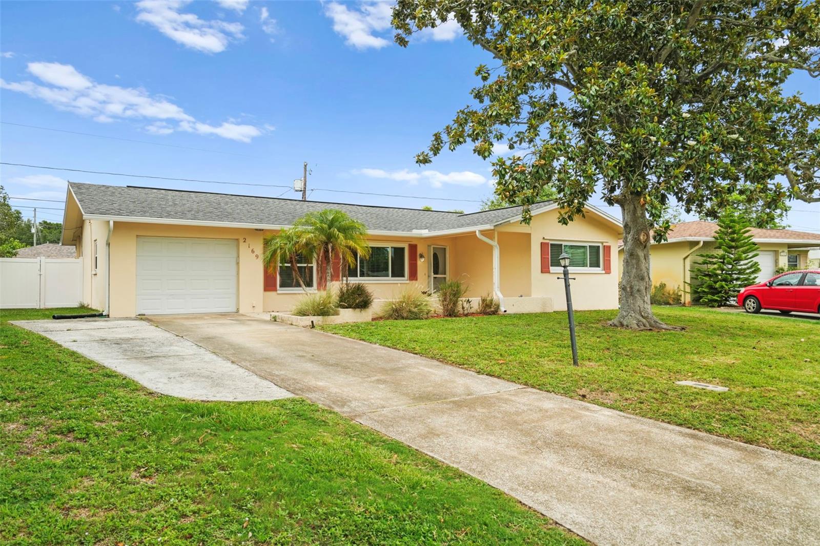 This spaciously updated, freshly painted, two-bedroom, two-bathroom home features an open concept and could be ideal for a first-time homeowner. It is centrally located, just minutes from downtown Dunedin, Countryside Mall, and several of Pinellas County's premier beaches. The updated kitchen features newer appliances and a brand-new oven. The large living room flows into the family room, which recently had vinyl flooring installed, making it an ideal space for a social gathering or holiday get-together. Just off the kitchen is a breakfast nook, which could also be used as an office. With a spacious backyard, there is plenty of room to entertain and let the family pet roam free. Over the last several years, most of the 4-point inspection concerns have been updated: 2021 windows/doors; 2019 roof; A/C 2024; and in 2019, the hot-water heater was replaced. Additionally, when the A/C was installed, new insulation was added as well to ensure efficiency. This property is priced to sell, requires no flood insurance, and has a low yearly HOA fee.