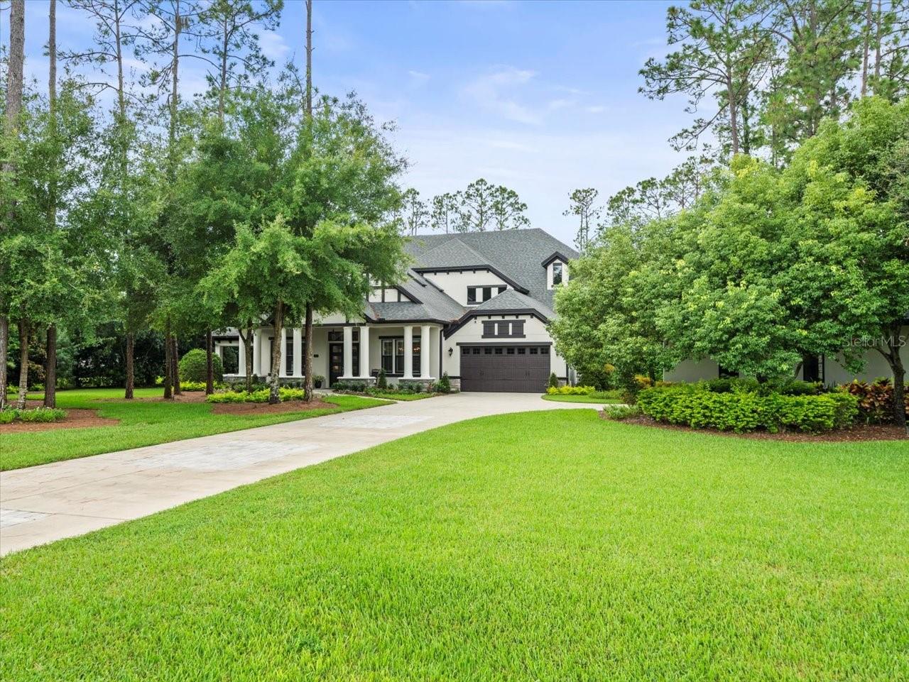 THIS EXQUISITE CUSTOM HOME IS STUNNING AND LOCATED IN THE HEART OF KEYSTONE/ODESSA. This beauty was constructed by the very respected Adobe Builders in 2016. Nestled within a gated community (Pine Cove Estates) of 11 home sites. This beautifully landscaped property boasts a very large private lot, approximately 1 acre, with an East facing orientation. providing stunning sunset views. The 5 Bedroom, 5.5 bathroom home is a testament to architectural excellence. As you approach, you will be captivated by the inviting glass double door entry, dramatic beamed cathedral ceiling, and beautiful chandeliers.  The main level offers a spacious living area featuring a beautiful gas fireplace, a master bedroom boasting luxurious bath and "to die for" walk-in closet, and a guest bedroom for the convenience of your frequent guests. The chef's gourmet kitchen is a culinary delight and designed for having the family gathered around while you prepare their favorite meals. Being equipped with built-in eating space, quartz counters, 42' wood cabinets, a tile backsplash, a Thermador gas range, plus a separate wine bar and refrigerator, affords you a luxurious space in which to entertain. The upper level features 3 bedrooms and a theatre room with a 100' projection TV...a great space to gather family and friends for those after dinner movies. The plethora of additional upgrades include a whole-house sound system for your enjoyment, custom plantation shutters, Crown molding, a central vacuum, and a water softener. With three Air Conditioning units, you will enjoy top notch climate control. The outdoor living space is your own private playground featuring a large covered lanai, heated pool, spa and an outdoor kitchen. Check out this custom built pavilion which includes bar height counters, a mounted TV, filtered water and icemaker, and a firepit for those enchanting nights under the stars, Bonus is your own private putting green!!! In addition to the oversized, attached 2 car garage, this home features a beautiful detached garage which is air conditioned and currently being used as a gym. The exterior and interior of the home have just been freshly painted to lighten and brighten this exceptional residence. The owners have also recently completed an extensive landscaping package to what was already an appealing property. This home is located within the A rated school districts. What more could you desire...see this beautiful home quickly while it is still available.