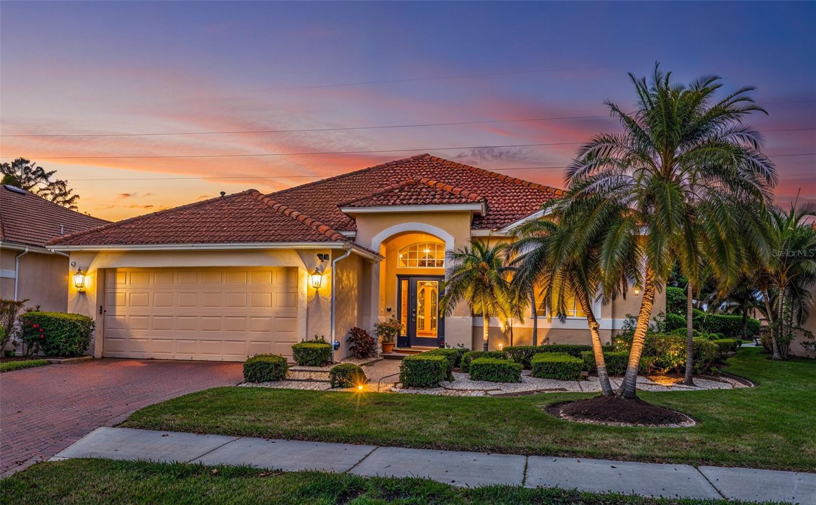 Virtually Staged. Step into style and comfort with this stunning 3 bedroom, 2 bathroom home located in desirable River Place, a gated community with NO CDD fee and LOW HOA, in beautiful Bradenton, FL. Upon arrival you’re greeted with curb appeal that features a paver driveway, well manicured lawn and flowerbeds. Step inside through the front door with double side lights, which sets the tone for the warmth and elegance found throughout the home. Once inside, you’ll find an abundance of natural light filling the entire home, enhanced by ceramic tile laid on the diagonal, rounded corners reminiscent of custom homes, soaring high ceilings, and upgraded light fixtures that add a modern touch. The heart of the home is the kitchen, featuring quartz countertops, a marble backsplash, GE Café stove and microwave, and a full suite of stainless steel appliances, all of which are less than 1 year old. An adjoining eat-in breakfast area with a charming aquarium window provides a bright and peaceful spot to enjoy your morning coffee while overlooking the outdoors. Whether entertaining in the formal dining and living rooms or relaxing in the family space, this home was designed for both function and style. A wall of large sliding glass doors opens to the patio, where the backyard delights with a variety of exotic fruit trees (mango, jamun berry, june plum, lychee, barbados cherry, olive, lemon, &Thai pink guava), creating your own private oasis. The grand primary suite offers a spacious retreat, featuring a large walk-in closet and a luxurious en-suite bath with dual sinks, a soaking tub, walk-in shower, water closet, and a makeup vanity—a perfect blend of relaxation and convenience. This home’s natural light, unique finishes, and timeless upgrades make it truly stand out. Seller is including a free standing generator for additional peace of mind. River place is a gated community that features a community center, tot lot, gym, & a kayak launch, all that is missing is you and your treasures to call this home.