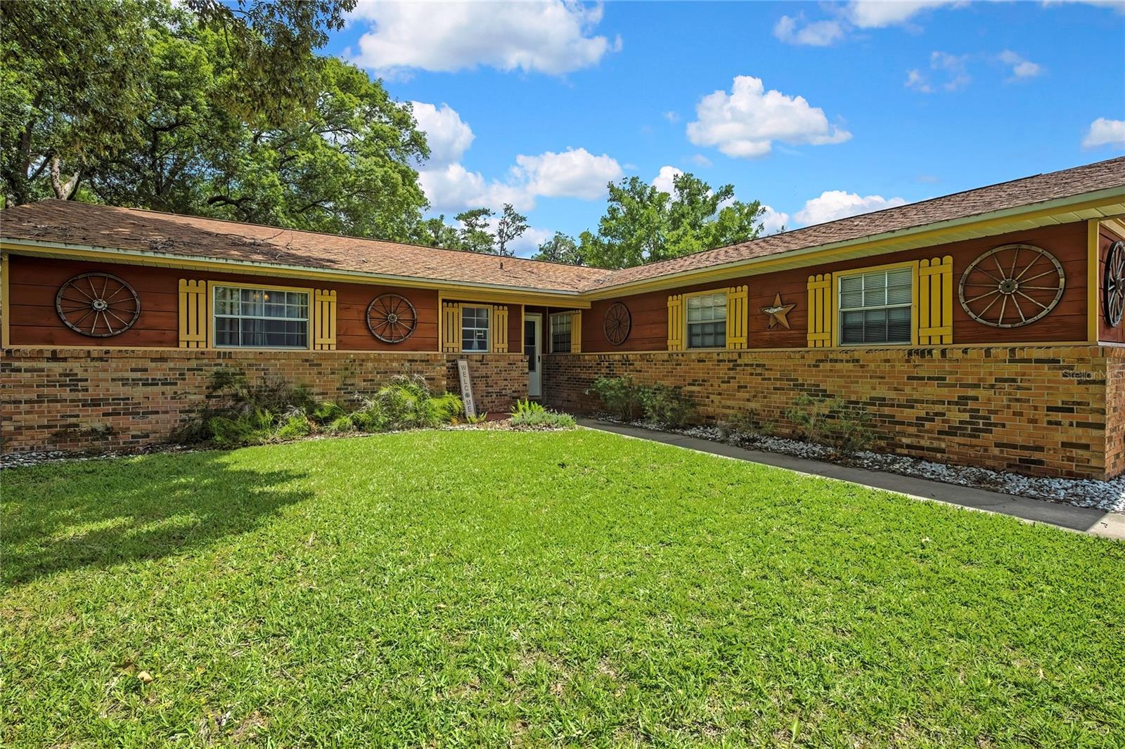 NO HOA! This charming 3BR/2BA concrete block & stucco home in SE Ocala’s Citrus Park neighborhood is a must-see. Featuring 1,580 sq ft of living area, the floor plan highlights an open living and dining space centered around a cozy fireplace. The large master bedroom includes two closets and a dedicated bath. Enjoy outdoor living on the spacious back porch overlooking a fully fenced yard. Structural perks include an oversized detached 2-car garage, architectural shingle roof, concrete slab foundation, and public city water/sewer connections. Conveniently located near shopping, dining, and schools—it's move-in ready and waiting for you!