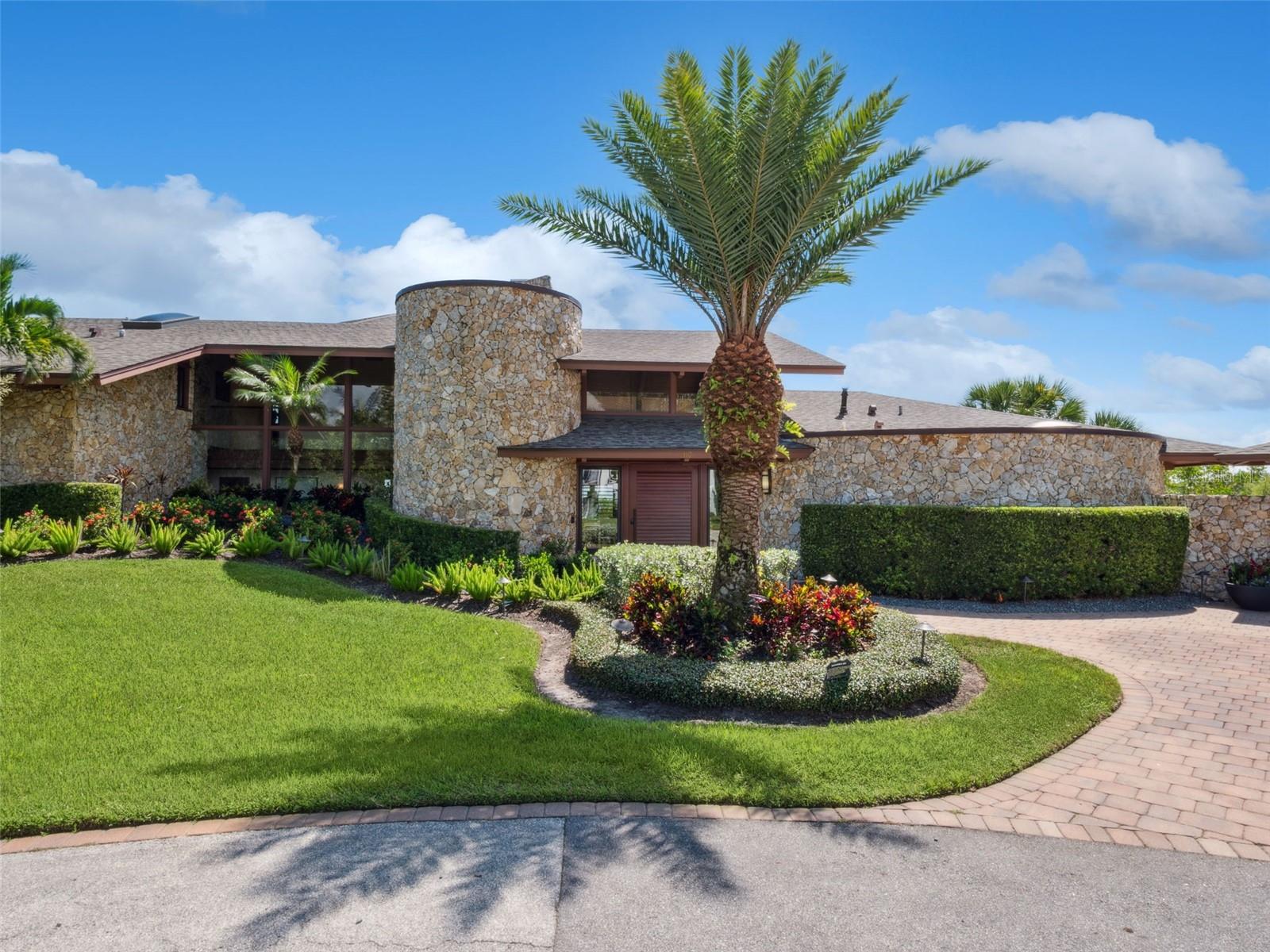 Experience the pinnacle of coastal luxury living in this extraordinary modern estate, a true architectural masterpiece designed by renowned architect Will Miller. Perfectly positioned along the pristine Intracoastal Waterway in New Smyrna Beach, this rare offering captures the essence of refined waterfront living with every imaginable amenity at your fingertips. Set on a lushly landscaped parcel with sweeping water views, this one-of-a-kind, fully furnished compound includes a spectacular main residence and an equally impressive guest house, together offering a total of 5 bedrooms, 5 full bathrooms, 2 half bathrooms, and an oversized 6+ car garage, ideal for auto enthusiasts, collectors, or those seeking ample space for recreational hobbies. The main home is a statement of modern elegance, featuring 3 spacious bedrooms and 3 spa-inspired bathrooms, all thoughtfully designed to maximize comfort and showcase panoramic views. At the heart of the home lies a chef's dream kitchen equipped

With top-of-the-line appliances, custom cabinetry, and sleek stone surfaces. Additional spaces include a dedicated media room, private office, versatile bonus room, and the showstopping "Sky Room", a glass-wrapped retreat offering breathtaking 360-degree vistas of the water and surrounding landscape. The guest residence mirrors the architectural brilliance of the main home, offering 2 bedrooms, 2 bathrooms, private balconies, its own Sky Room, and a fully appointed recreation and fitness center, perfect for hosting guests or accommodating extended family in total privacy and comfort. Step outside to your own private resort, where a self-cleaning saltwater pool with waterfall spa invites relaxation. Enjoy a host of resort-caliber amenities, including an infrared sauna, outdoor shower, game and fitness room, and a fully equipped outdoor kitchen, perfect for al fresco dining and entertaining under the stars. Designer-selected materials throughout, such as locally sourced hardwoods, natural Coquina stone, and floor-to-ceiling glass walls, create a seamless blend of organic textures and contemporary lines, bringing the outdoors in and immersing you in Florida's coastal beauty. Additional features, expansive rooftop terraces, 2 boat slips included with the property, and tropical landscaping that frames every view with natural serenity. This is not just a home, it is a rare coastal sanctuary, unmatched in craftsmanship, style, and location. Opportunities like this are few and far between in New Smyrna Beach. Schedule your private showing today and discover what it means to truly live on the water's edge.