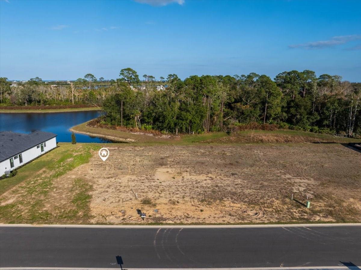Oversized homesite in the gated Intracoastal community of Veranda Bay. Lot 174 at 192 Stillwater Drive is cleared and build-ready, offering serene lake views and bordering conservation areas for added privacy. The east-facing rear orientation is ideal for outdoor living, capturing peaceful sunrises. Located on a quiet cul-de-sac and just a short walk to the community clubhouse.

Veranda Bay offers Intracoastal Waterway access and a planned marina, with opportunities for private docks. Community amenities include a resort-style pool, clubhouse, fitness center, tennis and pickleball courts, and a dog park. Public water and sewer, underground utilities, and approved custom builders are available. Buyers have up to five years to build their home.

Just one mile from Flagler Beach, residents enjoy quick access to beaches, dining, boutique shopping, golf, biking trails, and everyday services including grocery stores, medical offices, and I-95. Convenient to St. Augustine, Daytona Beach, Jacksonville, and Orlando, this location combines coastal living with easy regional access.