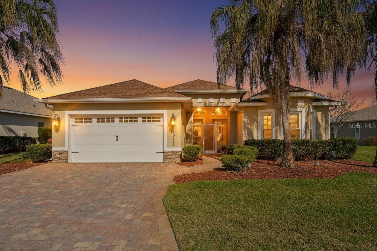 WATER VIEWS, WOW FACTOR & AN ALL-SEASONS GLASS-ENCLOSED LANAI YOU'LL NEVER WANT TO LEAVE! NO CDD & NO BOND!!!

Welcome to the Florida lifestyle buyers dream about. Tucked inside the TRULY GATED, AMENITY-RICH COMMUNITY of Lakeside Landings, just minutes from The Villages, this beautifully maintained 2015-built home offers 4 bedrooms, 2 bathrooms, and 2,319 square feet of bright, comfortable living with the kind of WATER VIEWS that instantly make you feel at ease.

From the moment you arrive, the BRICK PAVER DRIVEWAY and SCREENED FRONT PORCH create a WARM AND INVITING first impression. Inside, the home features tile flooring throughout the main living areas, PLANTATION SHUTTERS, RECESSEd LIGHTING, GRANITE COUNTERTOPS, and a desirable SPLIT-BEDROOM FLOOR PLAN that offers both privacy and functionality. The flexible 4th bedroom, which does not have a closet, is ideal for a HOME OFFICE, den, hobby room, or guest space.

But the true star of the show is the stunning, FULLY GLASS-ENCLOSED ALL SEASONS LANAI. Finished with luxury vinyl plank flooring and showcasing PANORAMIC WATER VIEWS with three beautiful fountains, this space is pure magic. Whether you’re starting your morning with coffee, winding down with a glass of wine, or simply soaking in the peaceful view, this is the kind of space that elevates everyday living and makes home feel like a RETREAT.

And the lifestyle does not stop at your front door. Lakeside Landings offers exceptional resort-style amenities, including a sparkling pool with waterfalls and fountains, a second pool, jacuzzis at both pools, pickleball and tennis courts, basketball, a playground, two dog parks, a fitness center, library, and billiards room. Plus, with The Villages just around the corner (JUST A GOLF CART RIDE AWAY!), you are close to shopping, dining, entertainment, golf, and all the everyday conveniences that make this location so appealing. Call today for your private or virtual showing and let's get you SETTLED IN SUNSHINE!