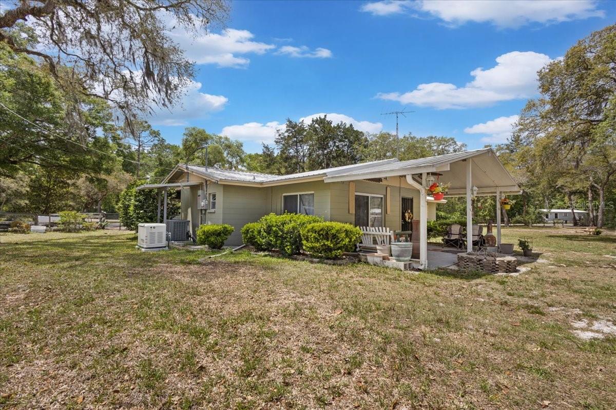 THIS property has it ALL! A solid concrete block home , 3 bedrooms / 2 bathrooms with a Den on 1 full acre in the quiet countryside with NO restrictions, minutes to the Manatee Springs State Park, Clay Landing public boat ramp to the Suwannee River and our local Golf and Country Club. A massive 40x20 RV Carport with a 30amp hookup, a 24x24 barn/workshop, a utility shed with private bathroom and insulated/enclosed perfect for a man cave or craft room or can be made into a guest house. A huge 62x40 pole barn with workshop, 50 amp RV hookup with power and dump station. This serene property is fully fenced with dual gates. Solid gorgeous home that has had every cell of
every block drilled and pumped with new insulation around the house as well as re blown in insulation in the attic. Nice open living room, kitchen with wood cabinetry , dining room, laundry room with additional space perfect for storage or pantry , a den perfect for additional family gatherings. Each bedroom offers ample space and 2 bathrooms, one with a combo shower/tub and master bathroom has a walk in shower. New LVP laminate wood flooring, solid metal roof, AC approx 10 years old AND brand new generac ONLY One year old. Convenient location to town for all your dining, shopping and medical needs. Call today for YOUR tour! Accepting ALL loans!