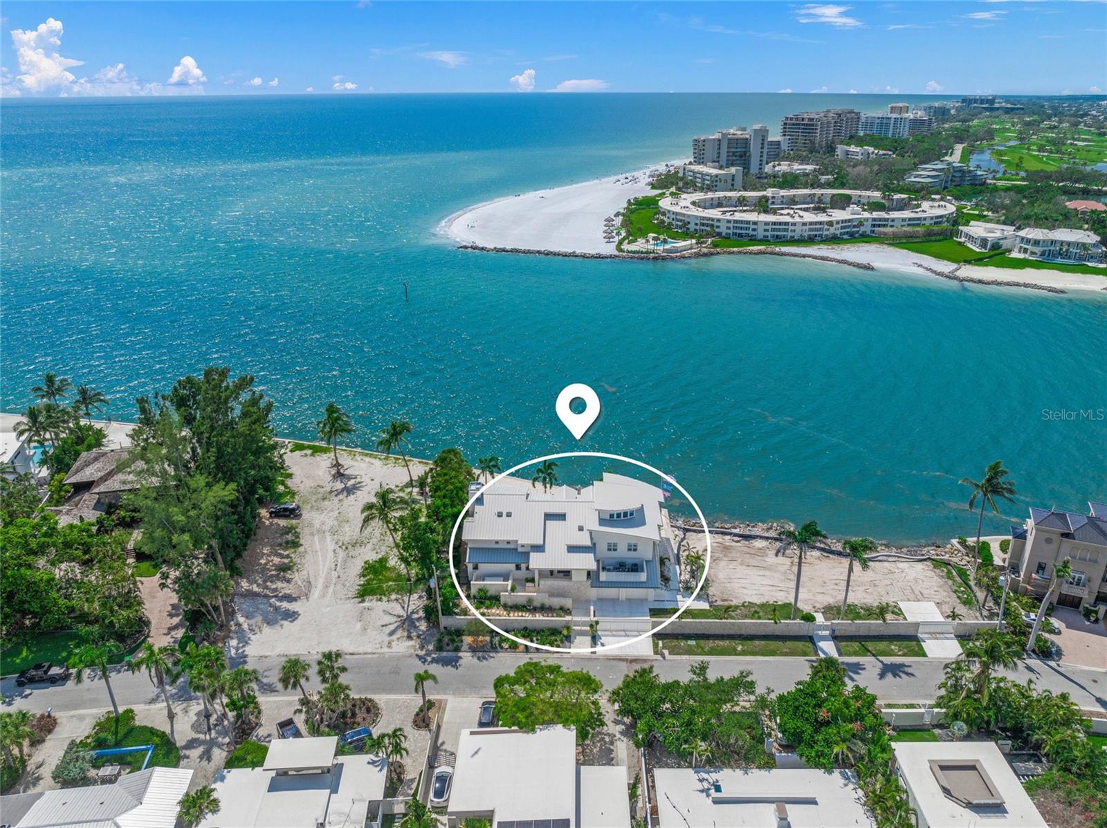 ONE OF THE LARGEST GULFFRONT ESTATES OFFERING STUNNING GULF VIEWS | LIDO SHORES | SARASOTA | Situated within the prestigious enclave of Lido Shores in Sarasota, this exceptional estate seamlessly marries architectural pedigree with unmatched natural beauty, offering the perfect balance of accessibility—just minutes from the vibrant St. Armands Circle and dynamic downtown Sarasota—all with complete seclusion and privacy. This is far more than a luxury residence; it represents a legacy property conceived by one of Southwest Florida’s most acclaimed architects, destined to endure as one of Lido Key’s most distinguished Gulf-front estates for generations to come.  Perched on the coveted Gulf of Mexico, this extraordinary estate represents the pinnacle of coastal luxury, designed by celebrated architect Clifford M. Scholz, founder of CMSA Scholz, Oswald & Shaffer whose vision transforms this super-sized pristine Gulf frontage estate into an architectural symphony of sophistication and modern elegance. This distinguished 6,862-square-foot residence commands stunning panoramic views of the Gulf, standing as one of Sarasota’s most coveted coastal properties where thoughtful scale and precise attention to detail converge in perfect harmony. The property is strategically elevated for optimal protection from storms (no water intrusion from storms). The interior unfolds as a masterclass in refined design, with soaring vaulted ceilings,  curated designer lighting, formal living and dining rooms framed by floor-to-ceiling glass with panoramic water views, generous gathering spaces, a sun-drenched breakfast nook, a versatile bonus flex room extends living possibilities just steps from the resort-style pool. At the heart of daily life lies a custom culinary masterpiece, anchored by an elegant La Cornue range and a matching commercial vent hood, a large butler’s kitchen, and a built-in bar for ease of prep and service for bespoke, large gatherings of family, friends or business associates.  The gourmet kitchen’s impressive arsenal includes a Sub-Zero refrigerator, Miele dishwasher, Bosch oven, Dacor microwave, and wine refrigeration. The residence’s five bedrooms, six full bathrooms, and two powder rooms provide luxurious accommodations for family and guests, including two distinctive guest suites featuring charming loft spaces. The serene primary suite serves as a private sanctuary, while two dedicated office spaces offer quiet retreats for productivity. The home’s wellness amenities include a traditional sauna and state-of-the-art infrared light therapy room, bringing spa-inspired luxury into daily life. Throughout the residence, sophisticated architectural details, including an elegant custom-crafted staircase and two inviting fireplaces, reinforce the home’s exceptional character and superior craftsmanship.  The outdoor living experience unfolds as a private resort oasis, where a stunning pool with cascading waterfall features becomes the centerpiece of the professionally designed landscaping that embraces and enhances the spectacular Gulf-front setting. The property’s distinguished presence is defined by Turkish white shell stone perimeter walls and elegant gates that provide both privacy and architectural gravitas. Generous grounds offer exceptional potential for expansion or additional structures, this remarkable property presents the rare opportunity to create a truly private family compound. (Adjacent parcel at may also be purchased in tandem.)