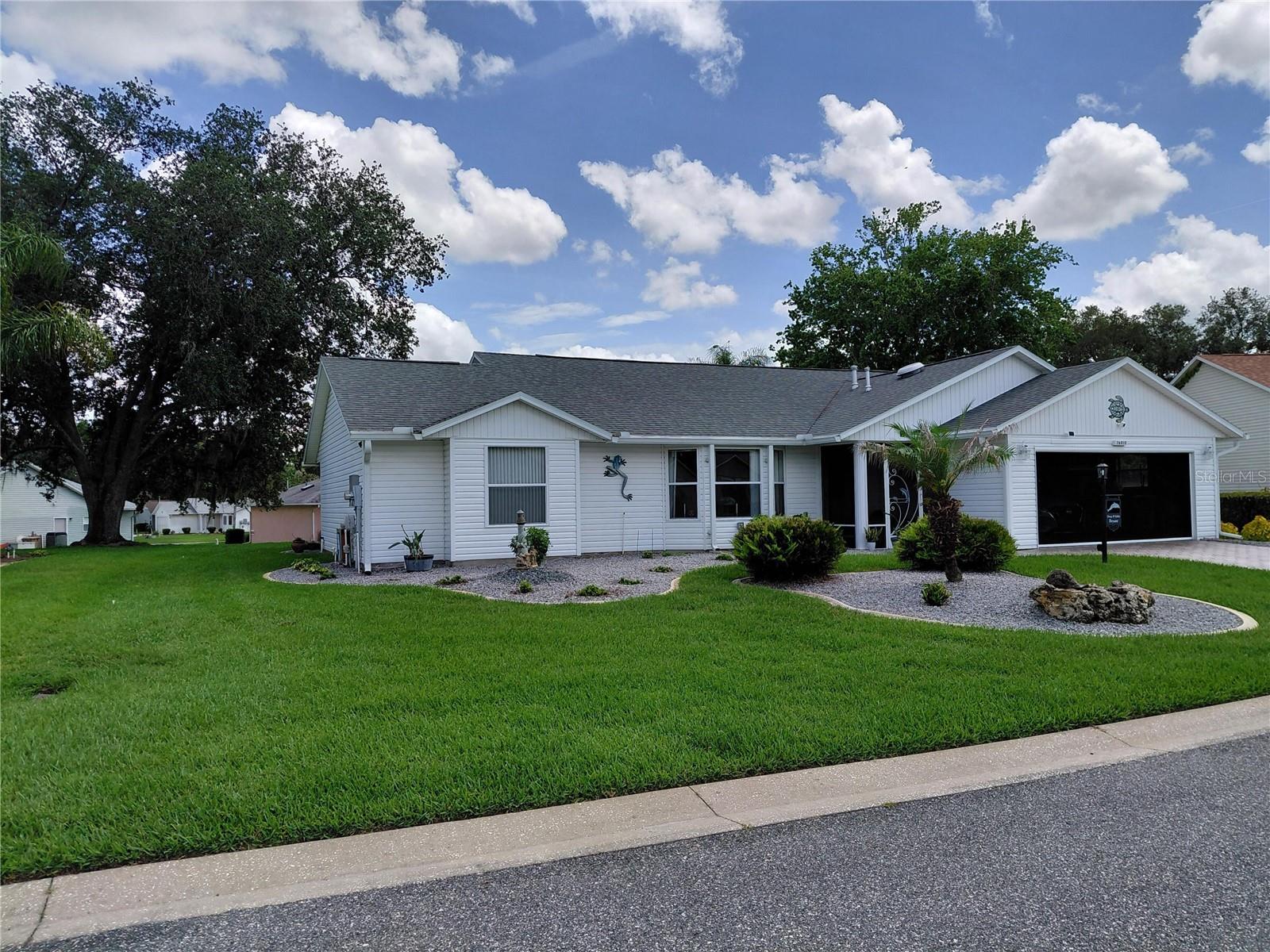 An inviting landscaped yard welcomes guests to an open concept floor plan 3-bedroom 2 bath 2091 sq ft, including a 190 sq ft- family room.  Laminate flooring and Italian tile in the wet areas.   A spacious front living room takes you through to the dining room with a pass- through kitchen with sky lights in both the kitchen and dinette. The kitchen has an abundant cabinet space and seamless flow into the dining room and other living areas. Granite countertops and stainless-steel appliances. Perfect layout of space. 
The laundry room is tucked off the kitchen with lots of cabinets. The laundry room leads to the 2-car garage with numerous cabinets and countertop space.  The 2-car garage has access to attic storage. Driveway is a paver style.
Split bedroom layout. Large master bedroom with walk-in closet and ensuite bath. Two bedrooms on the opposite side of the home with built in Murphy beds along with shelving and drawers.
Bright and airy family room leading to a Florida room. The Florida room opens to a large 20’ x 24’ (check size) screened bird cage with a view of a beautiful landscaped rear portion of the property.  The rear property has a solar lit flagpole as well. Enjoy relaxing mornings and evenings overlooking property.
Highland Lakes is situated in a premier neighborhood, you will enjoy access to a massive clubhouse, indoor and outdoor pools, tennis, pickleball, and fitness facilities.