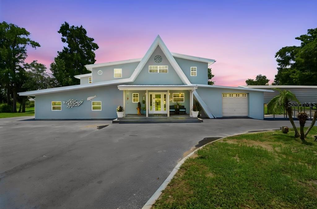Calling all boaters, fishermen, and anyone dreaming of true waterfront living! Welcome to one of Enterprise’s most unique canal-front homes in the desirable Brandy Cove community. Offering over 4,000 square feet of beautifully updated living space on a .86-acre lot, this exceptional home features 4 bedrooms, 4 full bathrooms, and a spacious bonus room. Situated on a scenic canal with direct access to beautiful Lake Monroe, this home is a dream for anyone who loves life on the water. Just steps away, you’ll enjoy exclusive access to the community’s private boat dock and boat ramp, making it effortless to launch your next adventure. Imagine spending your mornings fishing, afternoons cruising Lake Monroe, and evenings relaxing poolside while taking in peaceful canal views. Whether you’re boating, kayaking, or simply enjoying the scenery, every day feels like a vacation. Inside, you’ll find a stunning, fully remodeled kitchen featuring custom cabinetry, gorgeous quartz countertops, and the perfect space for gathering with family and friends. New tile flooring flows throughout most of the home, complemented by fresh interior and exterior paint, updated plumbing and electrical, and thoughtful improvements that provide both style and peace of mind. The spacious primary suite is a true retreat, complete with a private balcony overlooking the canal and pool with breathtaking water views. An adjoining bonus room offers endless possibilities as a nursery, home office, fitness room, private sitting area, or an incredible walk-in closet. The thoughtfully designed primary bathroom features dual vanities, two private water closets, and a shared walk-through shower, offering both convenience and privacy for couples. Two of the secondary bedrooms each feature their own private en-suite bathrooms, providing added comfort and privacy for family members or overnight guests, while the flexible floor plan easily accommodates a variety of living arrangements. You’ll also appreciate the oversized laundry room, abundant storage, and generous living spaces throughout. Additional upgrades include 11 energy-efficient mini-split systems, a brand-new septic pump, updated plumbing and electrical, a raised foundation approximately 36 inches above grade, and a yard elevated approximately 4 feet, providing added peace of mind. Outside, you’ll find a 1.5-car garage with three roll-up doors and dock-high access, a large metal RV/boat carport, and plenty of room to store your boats, RVs, trailers, and other recreational toys on nearly an acre of beautifully maintained property. Whether you’re an avid fisherman, boating enthusiast, nature lover, or simply searching for an exceptional waterfront retreat, 220 Brandy Court delivers a Florida lifestyle that’s hard to find. Priced below appraisal value, this exceptional waterfront opportunity offers incredible value. Schedule your private tour today and discover why 220 Brandy Court could be the dream home you’ve been waiting for.
