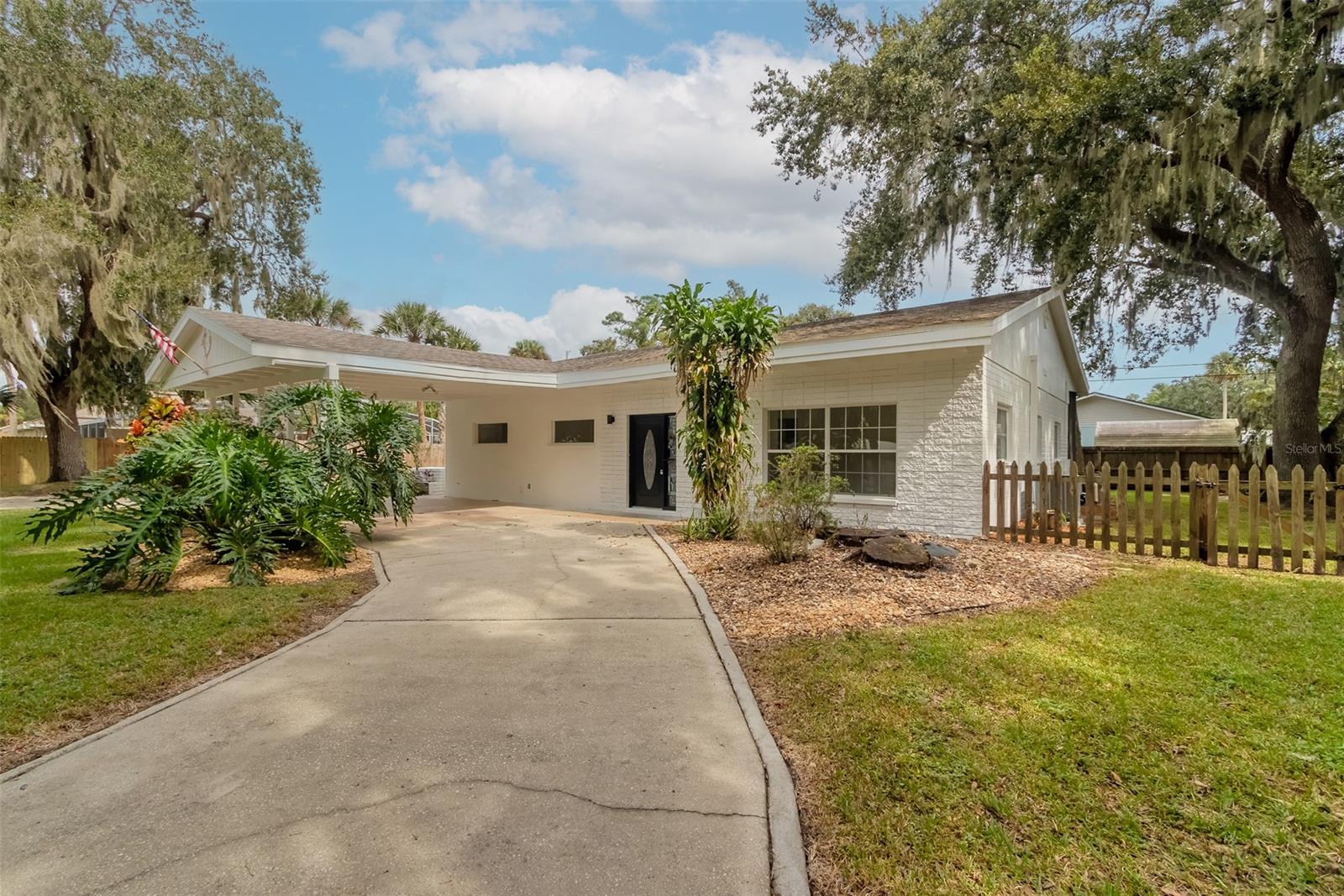 Get a $5000 closing costs credit and get ready to step back in time and experience the epitome of mid-century/modern living in this beautiful home nestled in a quiet and welcoming neighborhood, offering the perfect blend of vintage charm and modern amenities. This stunning home embodies the clean lines, open spaces, and iconic design elements that define the mid-century 1960s era. High ceilings w/ beams, large windows, and sleek lines create an atmosphere of elegance and simplicity. It perfectly marries the charm of the past with modern convenience, creating a living space that's as functional as it is fashionable. The kitchen boasts modern upgrades, including new stainless steel appliances with extensive modern cabinetry and updated countertops. New vinyl plank flooring, upgraded modernized bathrooms. new ceiling fans and light fixtures throughout, new interior and exterior paint. Large Spacious laundry room has a 1/2 bath and the FP opens into 2 separate living spaces. Enjoy endless summer days by your modern sparkling POOL, perfect for relaxation and entertaining. The spacious patio and cool deck area provides plenty of room for outdoor dining, lounging, and soaking up the sun. Situated on an expansive lot, this property offers endless possibilities...Expand the home, create a lush garden oasis, or build your dream outdoor entertainment space...the options are boundless. There is a 2 car carport and extensive parking for your boat and RV on this TRIPLE lot. Located in a quiet and friendly neighborhood, you'll find peace and tranquility while being just minutes away from Beaches, shopping, dining, schools, and waterfront parks. Don't miss the opportunity to own a piece of architectural history in this sought-after mid-century gem. ;Water: City