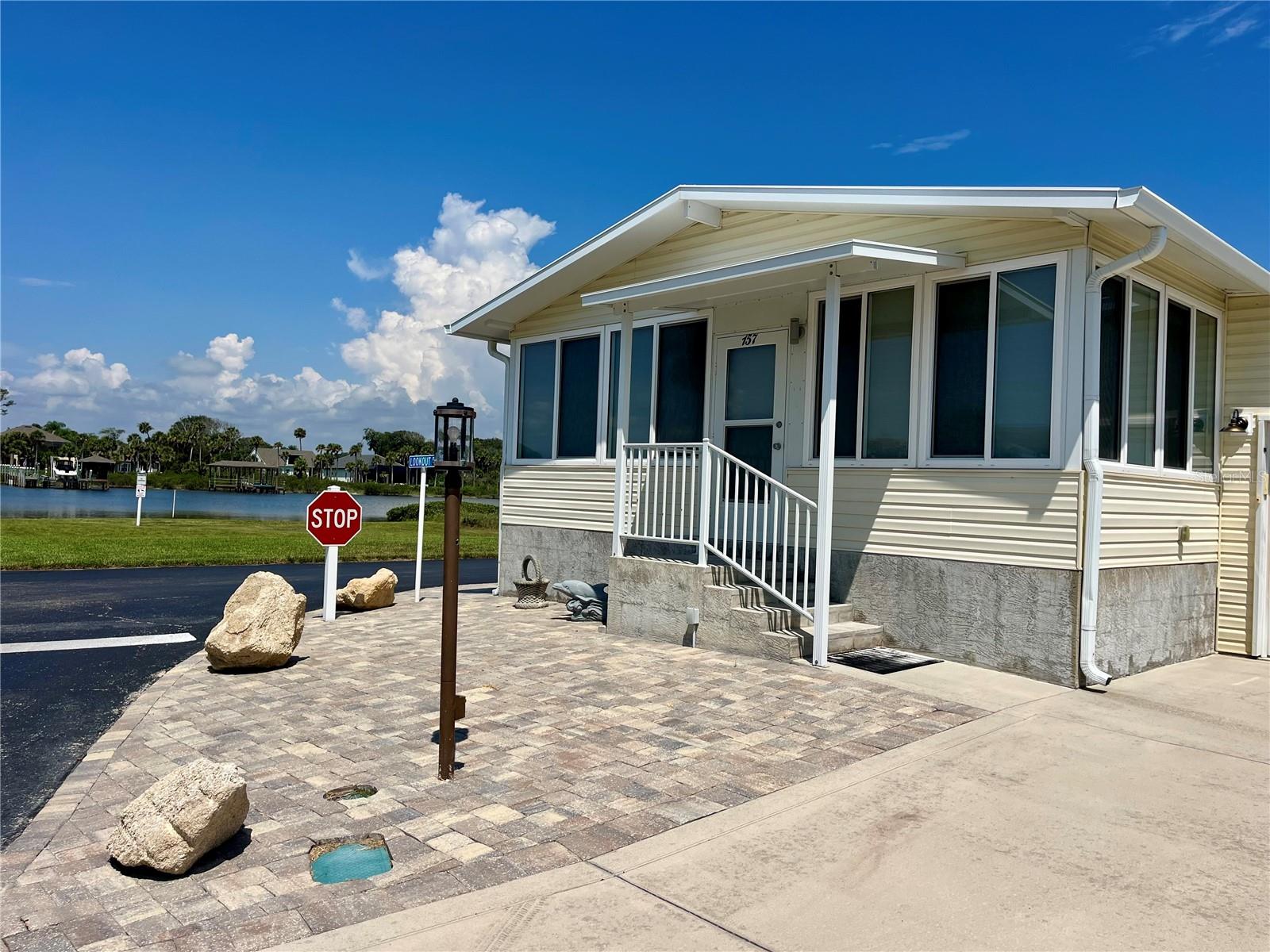 Wake up every morning with Intracoastal views from every window in this beautiful home! If you have been waiting for a newer, elevated home in Surfside Estates with all the bells and whistles, this may be the one you have been waiting for! Built in 2018, this spacious 2 bedroom 2 bath home offers an open floor plan, high ceilings, chef's kitchen with stainless steel appliances, center island, crown molding and luxury vinyl plank flooring throughout. This property is completed with a large enclosed front porch with spectacular views of the Intercoastal Water and it also has a coveted 12x38ft garage! Surfside Estates, an active 55+ resident-owned manufactured home community nestled between the Atlantic Ocean and the Intracoastal Waterway, this property offers the true Florida lifestyle. Best of all, there is no lot rent when you purchase here, you own a share of this beautiful beachside community. The low monthly maintenance fee of $220/mo includes Wi-Fi, internet, cable, lawn care, management, and access to all community amenities. Residents enjoy a heated/cooled inground pool, fitness room, library, shuffleboard courts, rooftop deck, kayak storage, BBQ area, gazebo overlooking the Intracoastal, and two community docks perfect for fishing, watching dolphins, or enjoying breathtaking sunsets every evening. The active Social Calendar offers endless opportunities to connect with neighbors, including bingo nights, card games, pool tables, exercise classes, water aerobics, and more. Walk across the street to the beach or hop on your bike or golf cart and explore everything in this coastal paradise. Just minutes away, the charming town of Flagler Beach offers local restaurants, shopping, and entertainment, while nearby mainland conveniences include hospitals, doctors, and additional shopping. Come experience this charming beachside getaway and claim your own piece of paradise! This home is furnished, and available for quick closing, come enjoy summer at the beach!