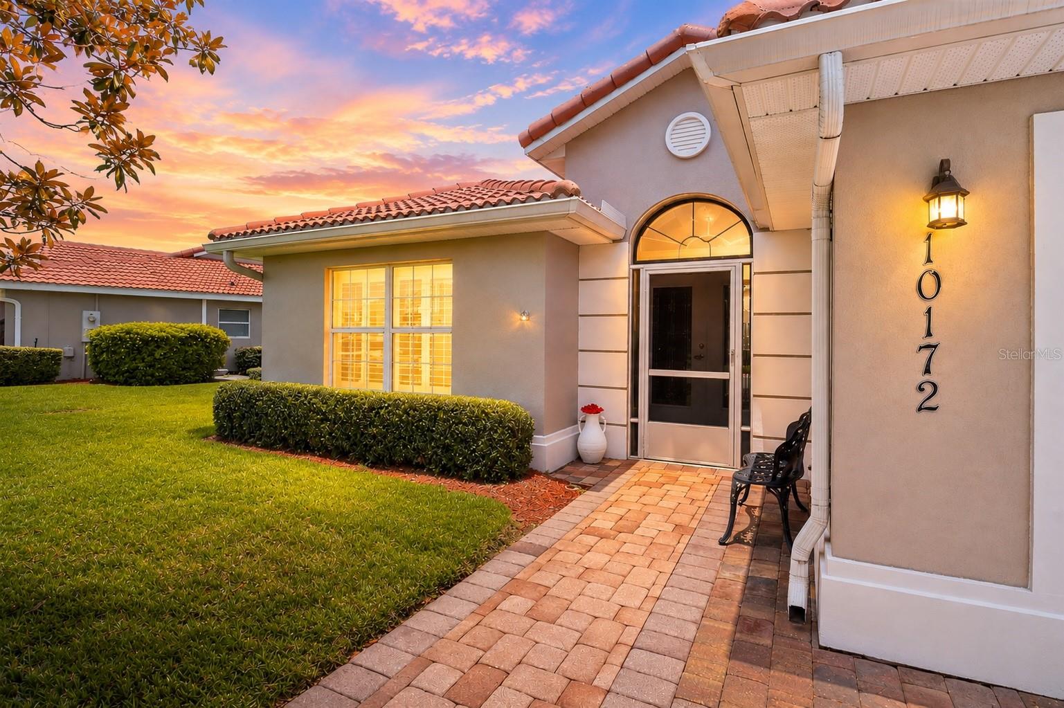 Beautifully maintained 3-bedroom villa with a STUNNING PRIVATE GARDEN OASIS in the GATED COMMUNITY of Lakeside Landings! Enjoy VAULTED CEILINGS, PLANTATION SHUTTERS, a SPLIT-BEDROOM FLOOR PLAN, BRICK PAVERS, and TRANQUIL OUTDOOR LIVING designed for relaxation.

Welcome home to this beautifully maintained 3-bedroom, 2-bath villa offering 1,592 square feet of comfortable, low-maintenance living in the highly sought-after, gated community of Lakeside Landings. One of this home's most enchanting features is its private backyard garden oasis—a PEACEFUL RETREAT where you can sip your morning coffee, watch the birds, or unwind at the end of the day surrounded by nature.

From the moment you arrive, you'll appreciate the BRICK PAVER DRIVEWAY that continues through the welcoming front entry and into the SCREENED FRONT PORCH, creating a warm and inviting first impression. Step through the ELEGANT LEADED GLASS FRENCH DOORS, accented by a beautiful TRANSOM WINDOW, into a SPACIOUS FOYER that opens to soaring VAULTED CEILINGS and a light-filled living area, creating an airy yet cozy atmosphere you'll immediately feel at home in.

The thoughtfully designed SPLIT-BEDROOM FLOOR PLAN offers privacy and comfort for both you and your guests. Throughout the home you'll find TIMELESS PLANTATION SHUTTERS, ceiling fans in every room, updated lighting in the foyer, dining room, and front porch, plus two newer ceiling fans with convenient remote controls.

The kitchen features neutral Corian countertops, while the bathrooms are finished with CULTURED MARBLE COUNTERTOPS, providing a clean, classic look that complements any style. The front guest bedroom has been FRESHLY PAINTED in the soothing Sea Salt color by Sherwin-Williams, adding a fresh coastal feel.

Enjoy added peace of mind with several important updates, including a 2023 water heater, 2023 double-door refrigerator, 2020 Whirlpool dishwasher, and a new garbage disposal.

The true showstopper, however, is the OUTDOOR LIVING SPACE. The SCREENED LANAI flows seamlessly onto an EXTENDED BRICK PAVER PATIO, creating the perfect place to entertain friends or simply relax while overlooking the beautifully landscaped backyard garden. It's a setting that feels PEACEFUL, PRIVATE, and INCREDIBLY SERENE—one you'll look forward to enjoying every single day.

Lakeside Landings offers resort-style amenities including a sparkling pool with waterfalls and fountains, a second satellite pool, jacuzzi, fitness center, pickleball and tennis courts, billiards room, library, card room, basketball court, playground, two dog parks, and access to Lake Miona for fishing and kayaking, all within a SECURE, GATED COMMUNITY. Even better — you’re just a quick golf cart ride from The Villages, where nightly entertainment, dining, shopping, and dancing await. NO CDD & NO BOND!!!

If you've been searching for a move-in-ready villa that combines low-maintenance living with beautiful outdoor spaces and thoughtful updates, this Lakeside Landings gem is one you won't want to miss.