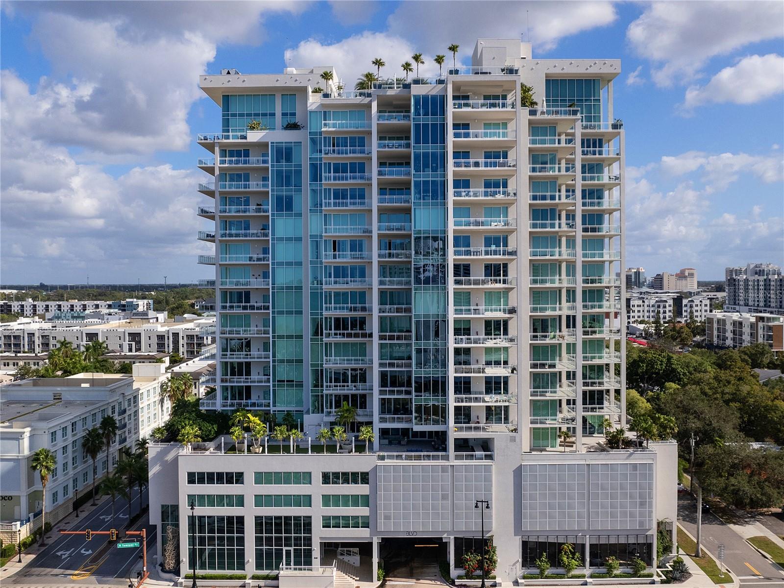 One or more photo(s) has been virtually staged. Set on the 15th floor, this sanctuary boasts unrivaled views, showcasing the expansive beauty of Sarasota Bay and an enchanting cityscape of sparkling lights. Indulge in a luxurious residence that truly harmonizes the spaciousness and feel of a single-family home with carefree condo living and resort-like amenities. As you step through the private elevator entrance, a foyer adorned with luxurious finishes sets the tone for the entire space with spectacular artist hand-painted walls, custom lighting and wood-look plank tile flooring that extends throughout the living areas. The great room, boasting lofty ceilings with custom coffered detailing, features a captivating stone accent wall housing media and a built-in fireplace. Floor-to-ceiling windows flood the space with natural light and open to a balcony offering boundless views of the barrier islands and downtown. In the kitchen, hand-painted walls shimmer and the designer tile backsplash complements the custom cabinetry. A central island, complete with a quartz countertop, beverage drawers, seating, and ample storage, anchors the space. A Sub-Zero and Thermador appliance package completes this culinary haven, including a gas cooktop, refrigerator, dishwasher, and wall double oven. Adjacent to the kitchen is a built-in bar area, featuring glass shelving, beverage cooler, drawers, and matching cabinet space, adding a sophisticated touch to entertaining. The primary bedroom is a sanctuary unto itself, boasting a private balcony and floor-to-ceiling windows that frame the outside world, together with two beautifully customized walk-in closets. The primary bathroom exudes comfort and functionality with an elongated vanity adorned with white cabinets and quartz countertops, a soaking tub, a walk-in glass shower, and expansive windows offering a surplus of natural light. Seamlessly merging indoor and outdoor spaces, three private terraces offer an oasis for contemplation and enjoyment, providing sweeping vistas that extend to Siesta Key, Lido Key, and Longboat Key.  Other amenities of this residence include two guest suites, a beautiful workspace, a large laundry room with an abundance of cabinets and quartz countertops, significant storage, two garage spaces, and more. Impeccable services, such as full-time concierge, a rooftop deck with a zero-horizon pool, state-of-the-art fitness facilities, club room, wine room, dog grooming salon and park, and an indoor golf simulator boasting ninety courses elevate the experience. Crafted by the esteemed Kurt Lucas, renowned for iconic projects like the Ritz-Carlton Sarasota and Concession Golf Club and Residences, BLVD Sarasota stands as a pinnacle of enjoyment nestled between the Bay and the vibrant heart of downtown Sarasota. Discover a realm of refined living, where luxury meets sophistication in an unparalleled setting. Priority golf membership to Lakewood Ranch Country Club available. Bedroom Closet Type: Walk-in Closet (Primary Bedroom).