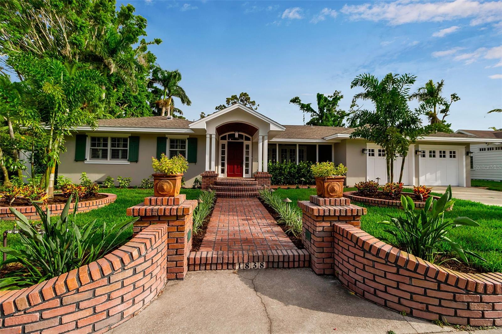 Ensconced in the heart of the highly esteemed West-of-Trail Avondale neighborhood, this stunning 5-bedroom, 4.5-bath, 4400 square foot residence seamlessly blends timeless charm with modern luxury. Situated on a rare 14,750 sq ft oversized lot, the original 1952 home was extensively renovated and thoughtfully expanded in 2022, more than doubling its original square footage—all on a single level.  Step inside to discover an open-concept layout designed for both comfort and entertaining, featuring a state-of-the-art kitchen with custom cabinetry, high-end appliances, a spacious eating area, and an impressive full butler’s pantry. The kitchen flows effortlessly into the elegant dining room and the great room, all bathed in natural light and finished with premium materials throughout.  The home offers a separate formal living room and a versatile bonus room overlooking the pool—ideal for a home office, library, or sunlit sitting room. The owner's suite features sliding glass doors to access the pool, transom windows that filter in natural light, two walk-in closets, and top of the line finishes in the spa-like bath.  The guest wing offers an over-sized bedroom, perfect for a home gym or private in-law suite, and provides privacy and flexibility for guests or multigenerational living.  Every detail has been meticulously curated, from designer finishes to thoughtful storage solutions. Outside, enjoy lush landscaping, generous green space, and the perfect setting for outdoor entertaining.  The lap pool and spa offer privacy and access to indoor-outdoor living spaces.  All of this is located in the highly sought after Southside Elementary School district, and within walking distance to downtown Sarasota and Southside Village, placing dining, shopping, and cultural attractions just steps from your door.