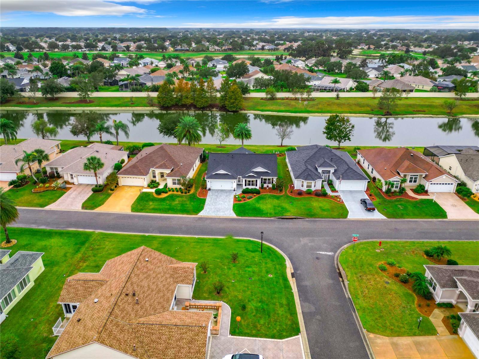 Welcome to a life of relaxation, recreation, breathtaking views, and convenient access to the heart of The Villages! This 2BD+Den/2BA home invites you into a world of comfort and style, offering an open and airy design that bathes every corner in natural light. Your private lanai invites you to enjoy the serene scene of a spectacular water view, turning your home into a tranquil waterfront retreat. Located in the Village of Tall Trees, this residence offers easy access to Lake Sumter Landing Town Square, where nightly entertainment, daily boat rides on Lake Sumter, and a diverse array of shopping and dining venues await. Don't miss out—call us today to discover the TOP 5 reasons why this home, with its captivating water view and private lanai, is a must-see and a great buy!
