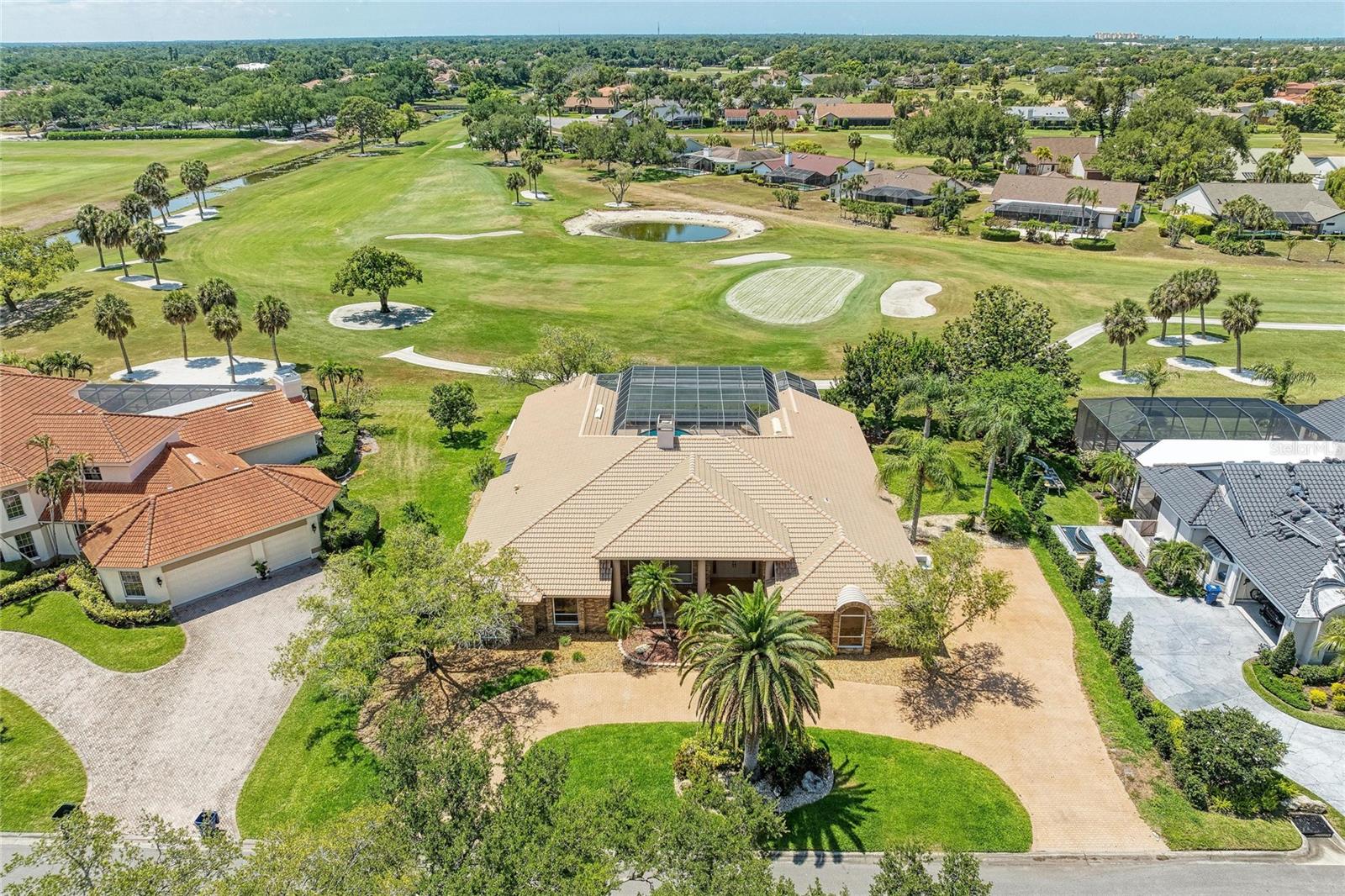 Behind the gates of Prestancia's coveted Estates section, this fully renovated Sarasota residence captures the kind of Florida living buyers move here hoping to find: private, peaceful, and effortlessly refined. Set on an oversized homesite overlooking the manicured fairways of TPC Prestancia, the home blends timeless architecture with a fresh, modern interior designed for the way people live today. Inside, soaring ceilings, oversized windows, and expansive living spaces create an immediate sense of openness and light. The redesigned kitchen anchors the home with clean contemporary finishes, generous prep space, and seamless connection to the surrounding living and dining areas, all oriented toward the outdoor entertaining spaces and golf course views beyond. Designed for effortless single-level living, the floor plan offers a rare combination of scale and livability. The private primary suite, dedicated office, guest accommodations, and expansive living spaces are thoughtfully positioned to maximize comfort, functionality, and privacy. Large windows and multiple access points to the lanai blur the line between indoors and out, allowing the home to live as beautifully outside as it does inside. Outside, the resort-style pool and expansive deck are framed by lush landscaping and wide golf course vistas, offering exceptional privacy and space to entertain, unwind, or simply enjoy Sarasota's year-round sunshine. Located within one of Sarasota's most established gated communities, Prestancia offers 24/7 guarded entry, mature tree-lined streets, Audubon-sanctioned surroundings, and optional access to championship golf, dining, and social amenities. Just minutes from Siesta Key Beach, downtown Sarasota, The Legacy Trail, shopping, dining, and the area's renowned arts and cultural attractions, this is a rare opportunity to own a move-in ready estate in one of Palmer Ranch's most desirable luxury communities.